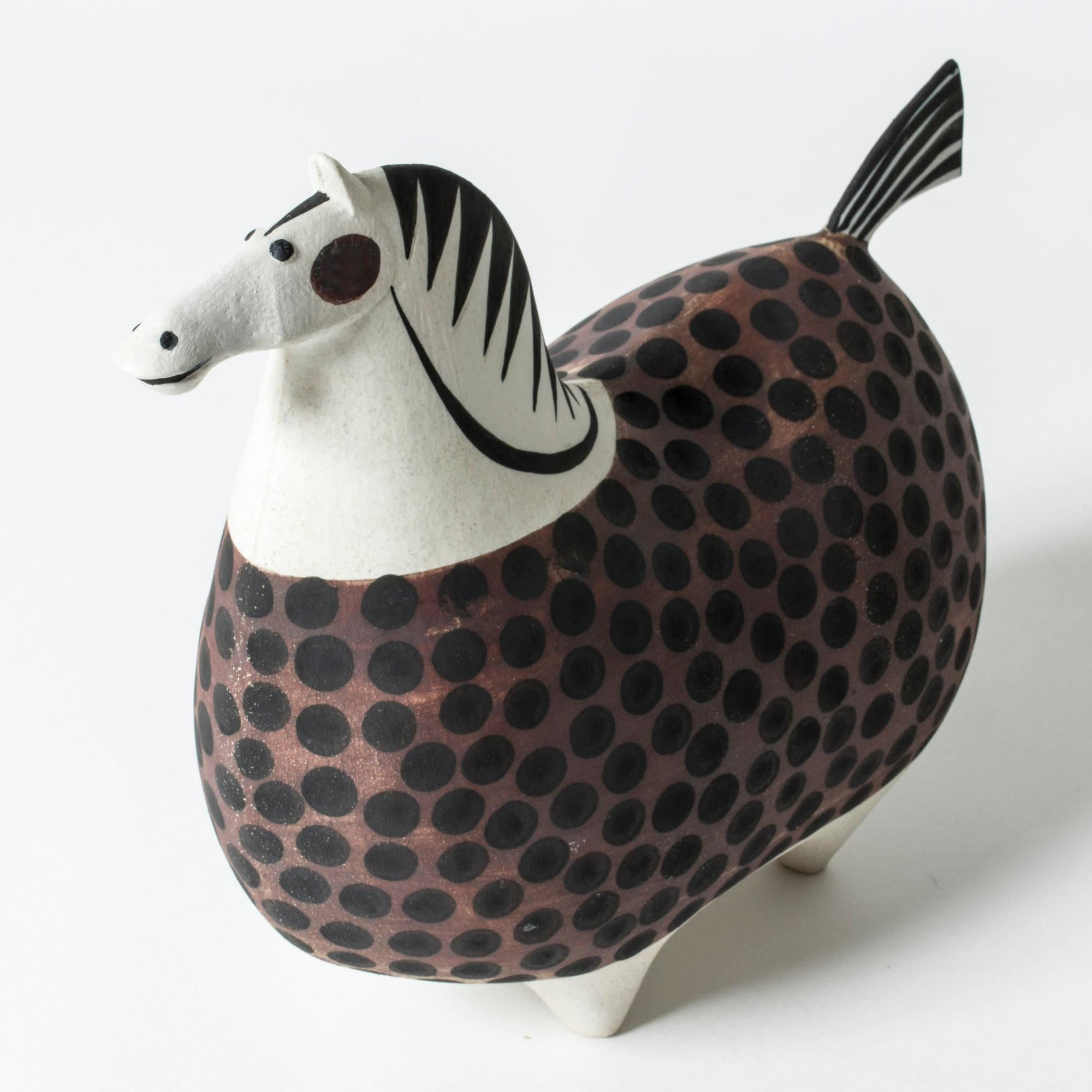 Enchanting ceramic horse figurine, “Springare”, by Stig Lindberg. “Springare” means “Steed”. This design was executed in different sizes at Gustavsbergs Studio, this size is among the larger and rarer. The stylized horse is painted with a brown and