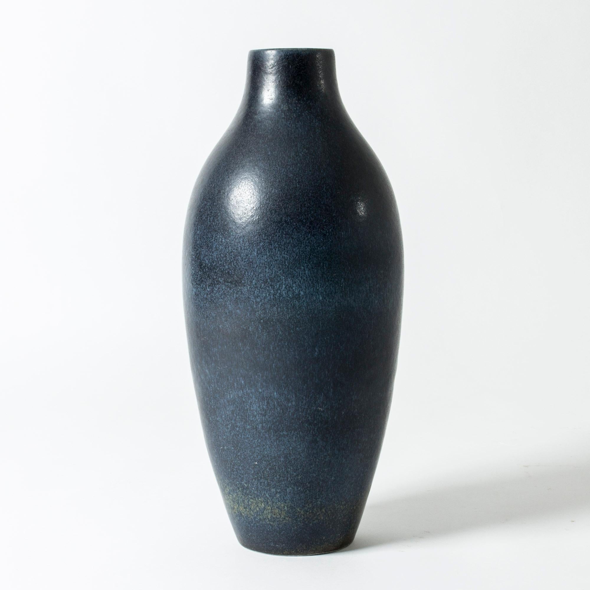 Statuesque stoneware floor vase by Carl-Harry Stålhane, in a clean form with beautiful dark blue hare’s fur glaze.

Carl-Harry Stålhane was one of the stars among Swedish ceramic artists during the 1950s, 1960s and 1970s, whose designs are just as