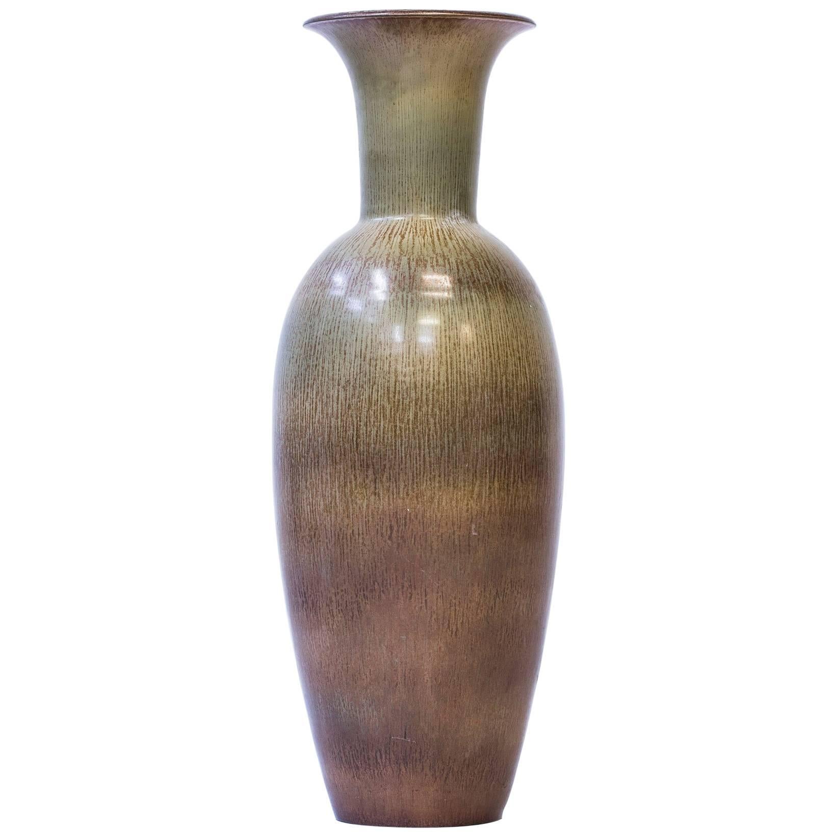 Large floor vase designed by Gunnar Nylund. Rare model and the largest that was designed by Nylund and serially produced by Rörstrand during the 1950s. Rare polychrome glaze shifting in green, brown and yellow tones. Excellent condition with light