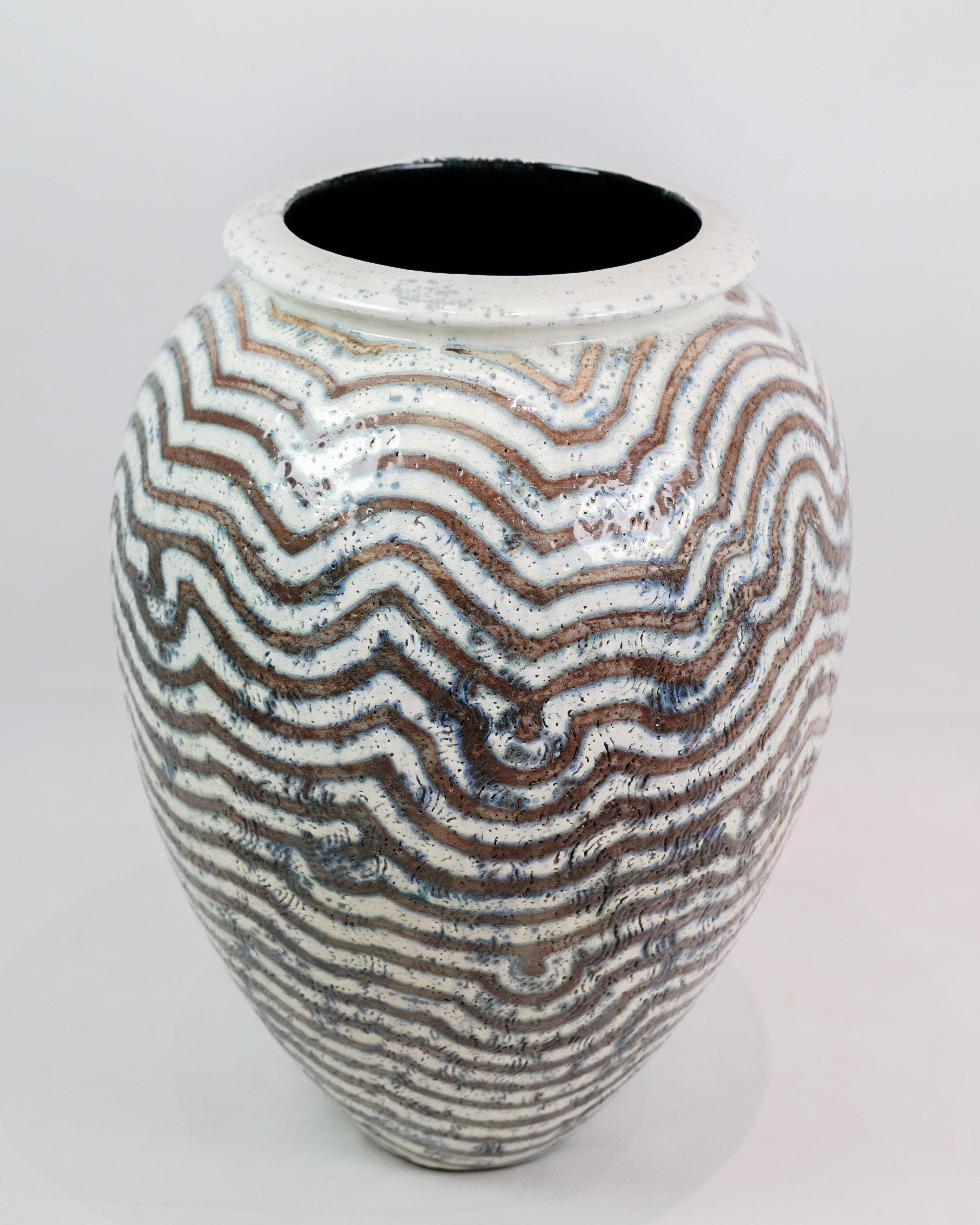 Spruce up your home with a unique statement piece - a large stoneware floor vase, designed and glazed by the talented Per Weiss in a beautiful combination of blue, gray and white colours. Created with care and originality, this vase exudes a