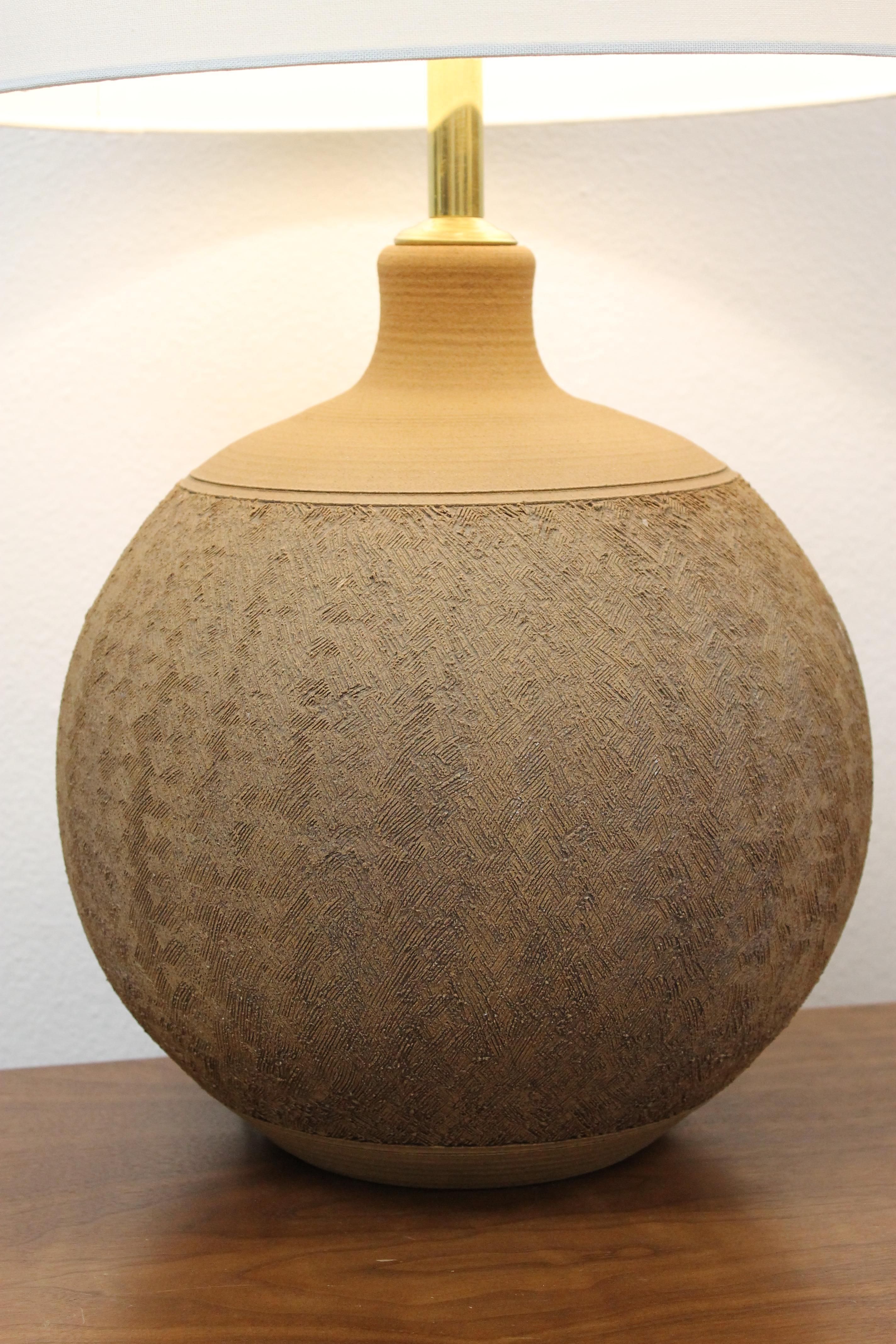 Stoneware lamp consisting of a stylized pattern throughout. Signed Brown. Stoneware portion is 14