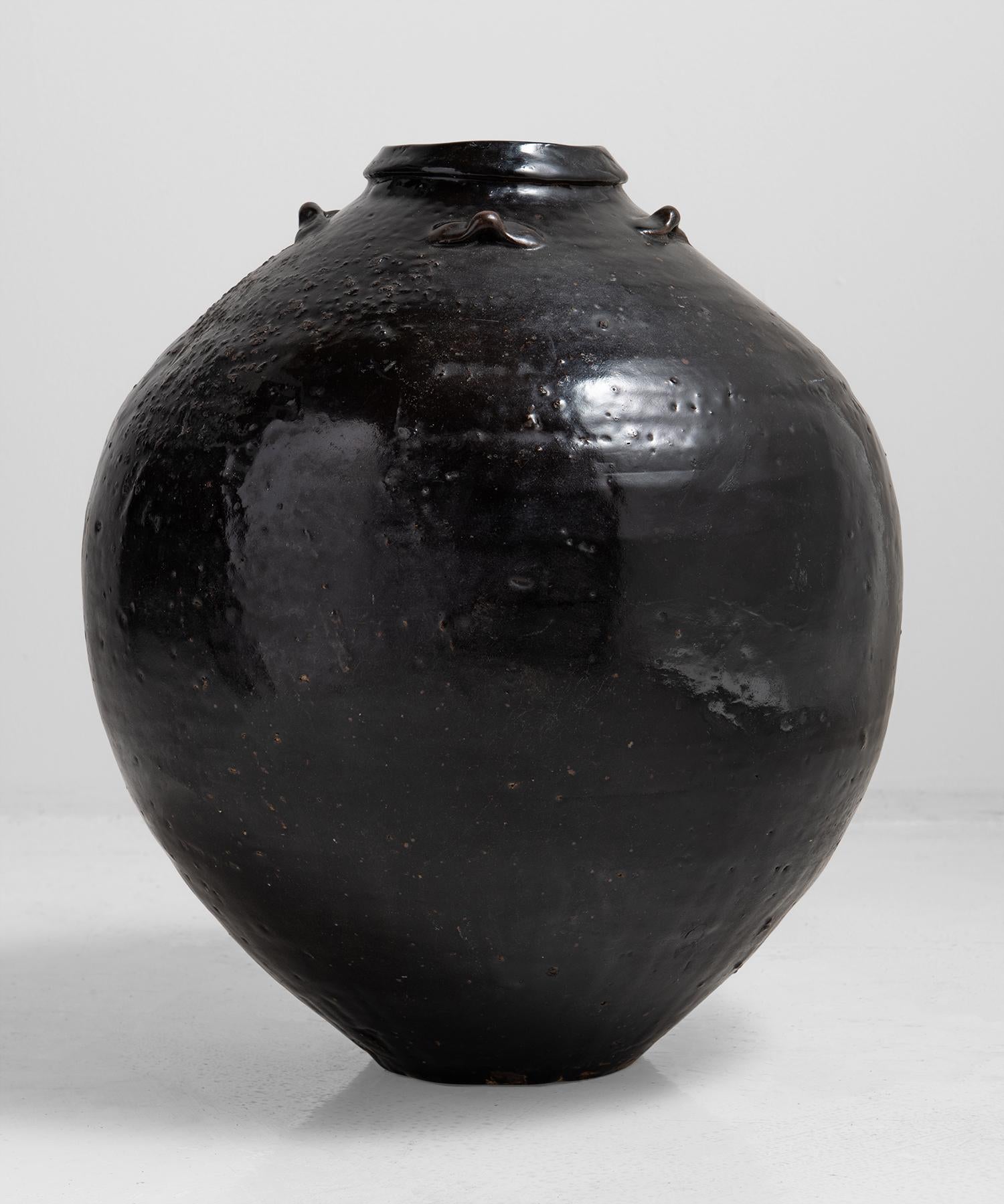 Ovoid body with tenmoku glaze and four small lug handles.
