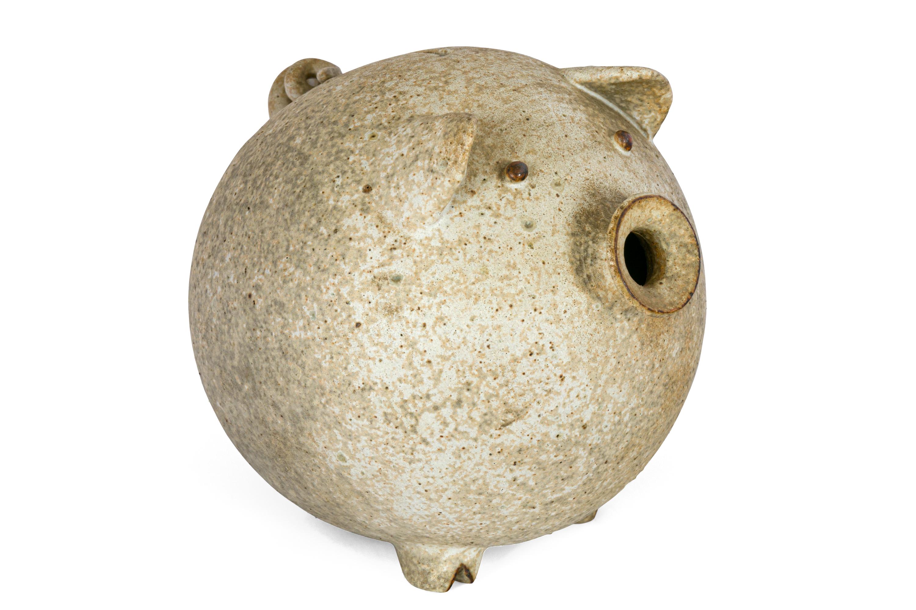 A playful and functional piece of pottery until the day you decide to empty out the coins. Until that time you will have the pleasure of enjoying a wonderfully whimsical piece of sculptural pottery.