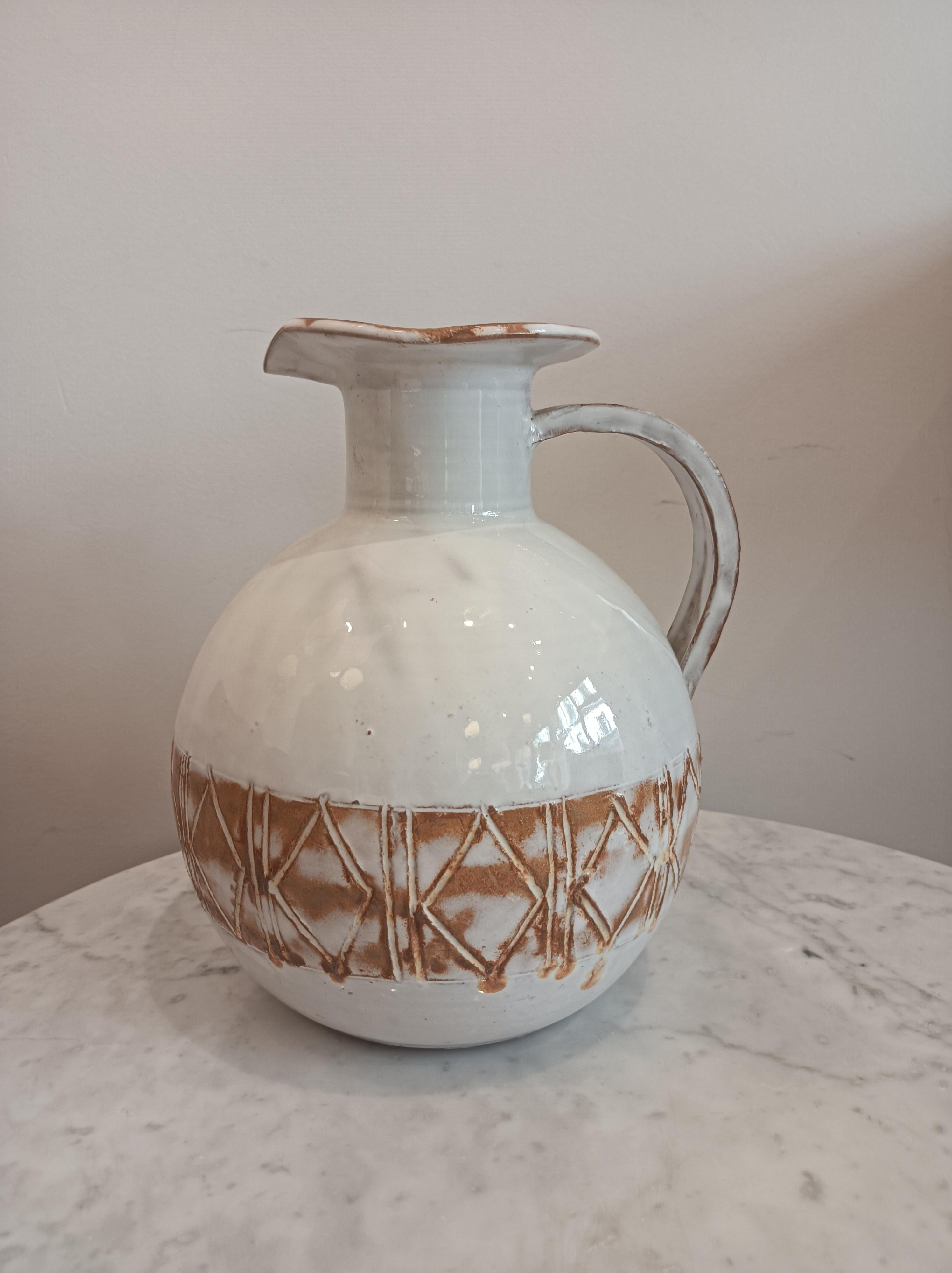 Stoneware pitcher by L'atelier les argonautes. 
Off-white glaze with geometric decorations. 
Signed 