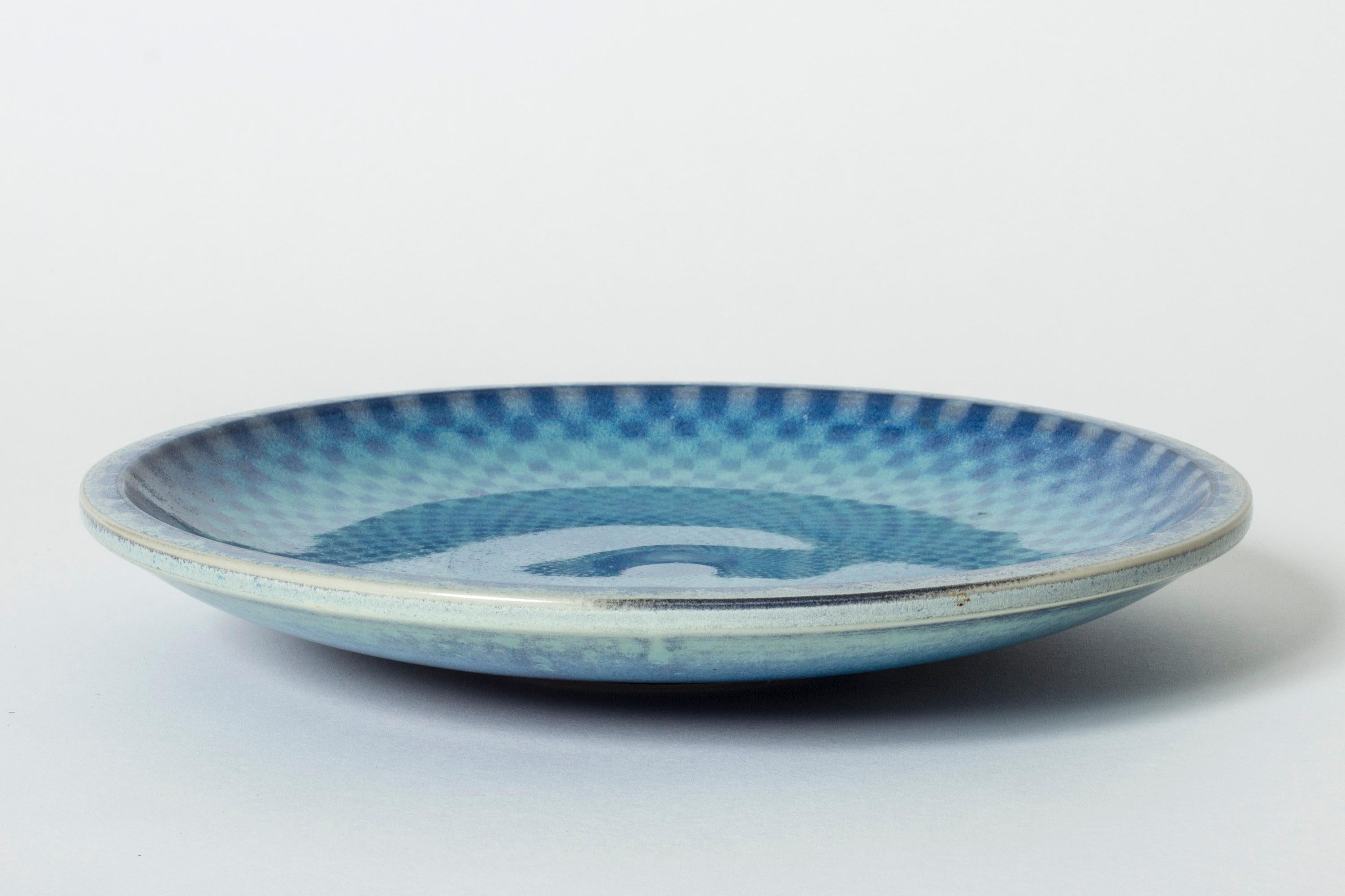 Striking stoneware platter by Berndt Friberg, with a checkered decor in aquamarine, blue and purple. Heavy quality.

Berndt Friberg was a Swedish ceramicist, renowned for his stoneware vases and vessels for Gustavsberg. His pure, composed designs
