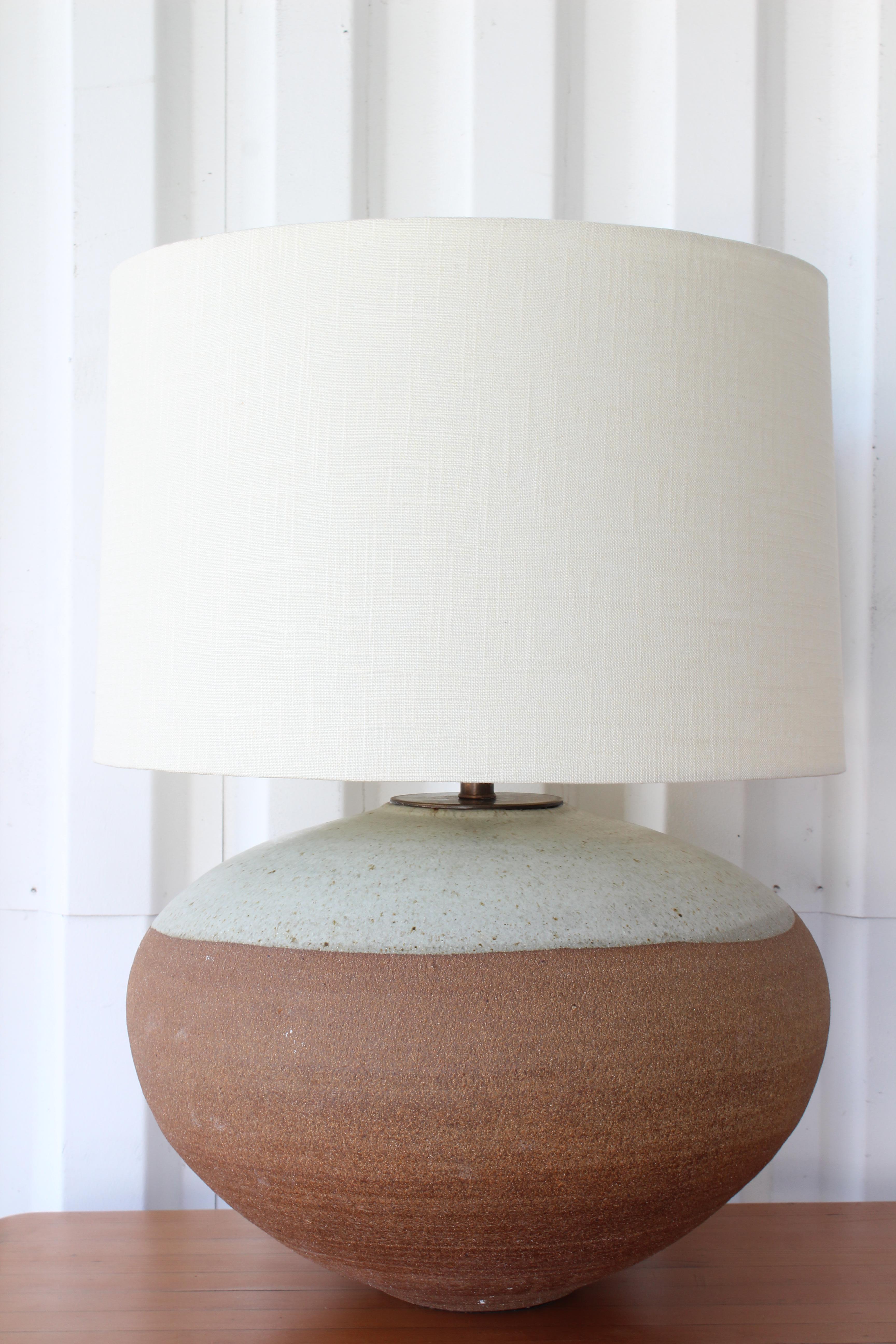 1960s studio stoneware pottery lamp. Newly rewired with custom made shade in Belgian linen. 
26