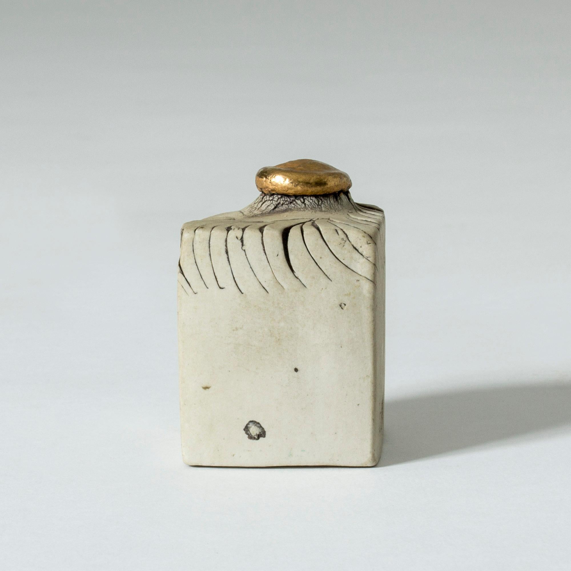 Precious little stoneware sculpture by Bengt Berglund in a suggestive shape. The top knob is coated with 24-karat gold. The perfect gold wedding gift, perhaps.