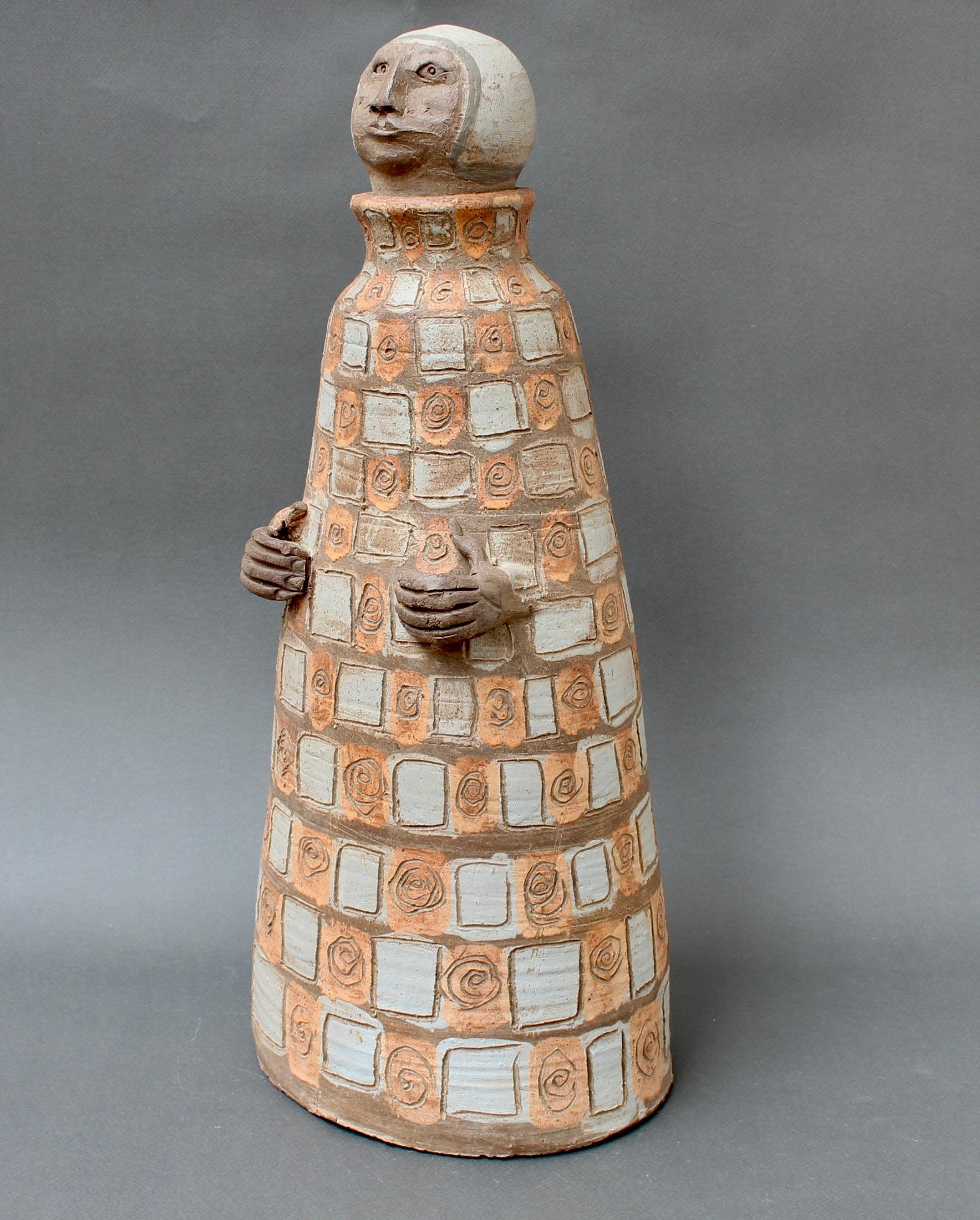 Vintage French earthenware sculpture of a man, by Albert Thiry (circa 1990s). Not one of his usual subjects, ceramicist Thiry created this figure wearing the garb and cap of a medieval monk, his hands placidly held at the waist. On the robe is an