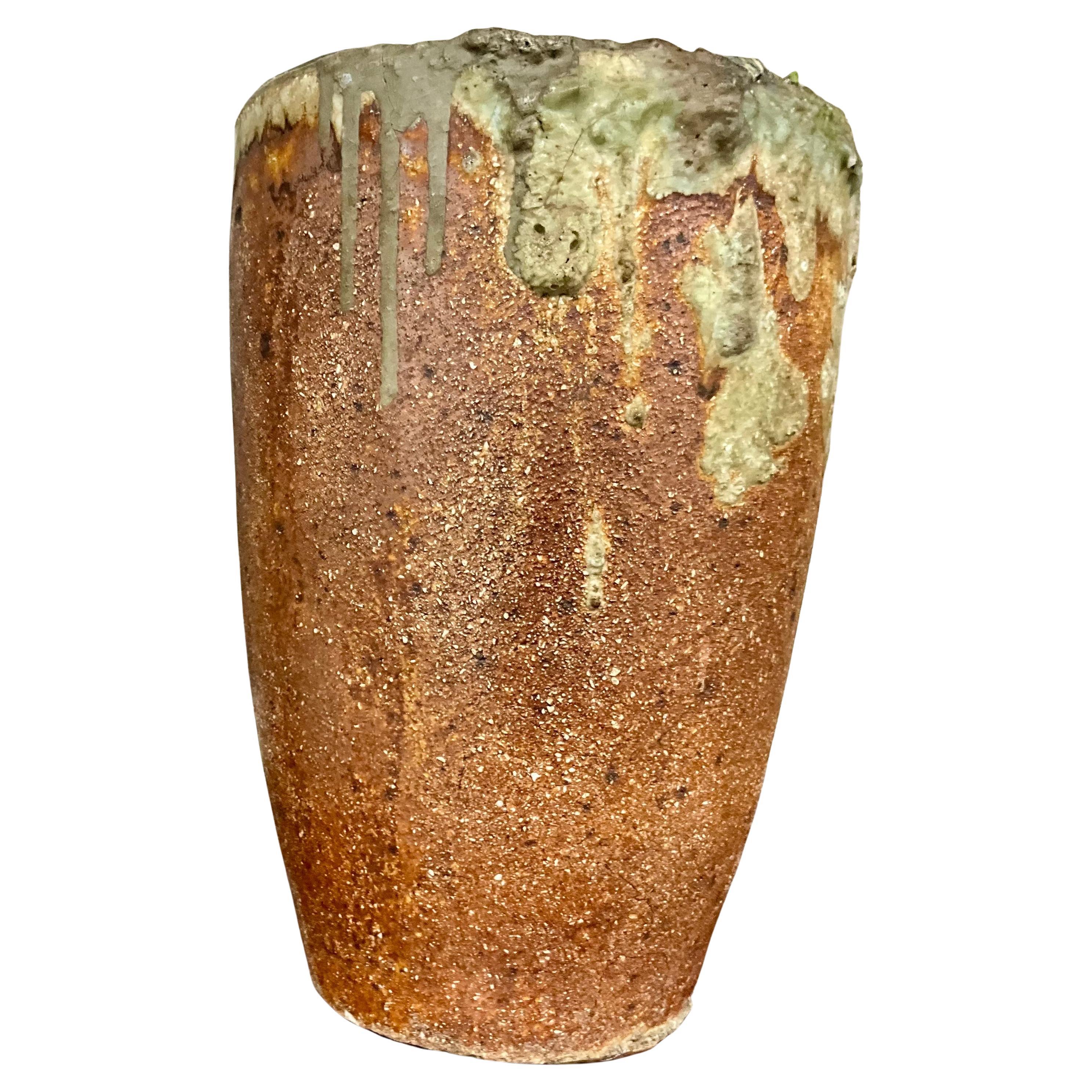 Stoneware Studio Pottery  Lava Glaze Vase Mid 20th Century MCM

 This mid-20th century stoneware vase features a stunning lava glaze, showcasing a rich texture and a captivating interplay of colors. The exterior exhibits a unique cracquelure finish,