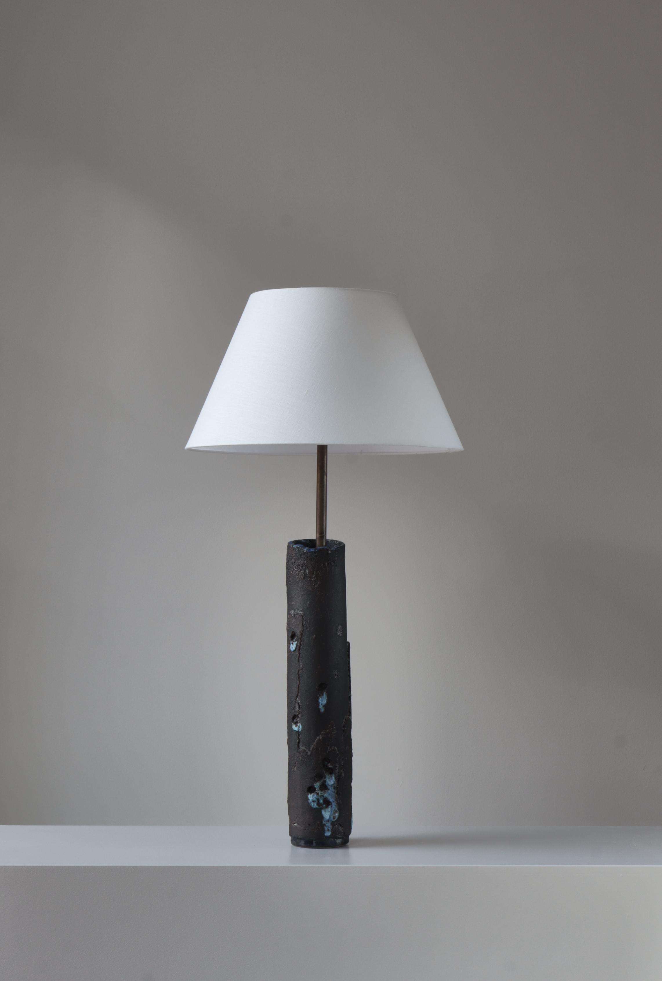 Unique stoneware table or floor lamp by Ole Bjørn Krüger (1922-2007) made at his own studio in the 1970s. The base is made from a large hollow stoneware vessel with lava-like glazing with vibrant colours typical for Krügers work. Mounted with a new
