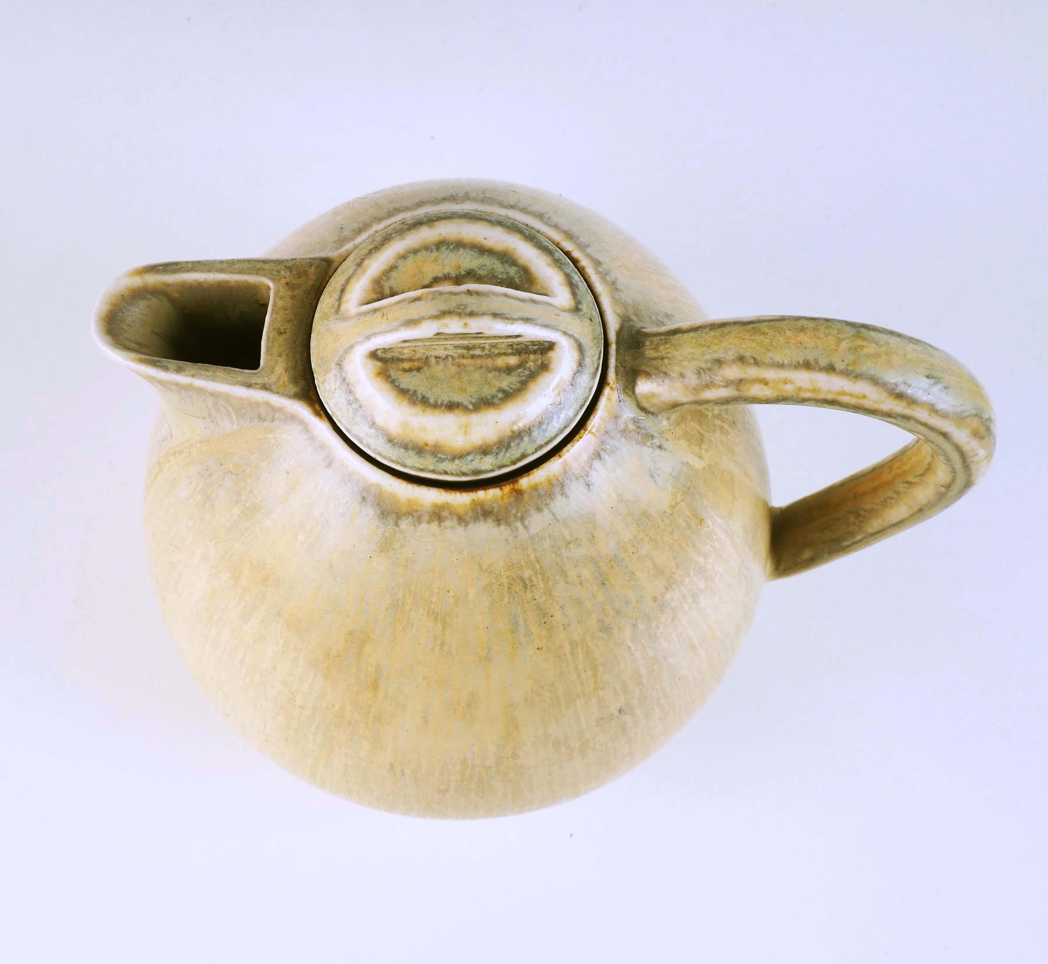 Stoneware teapot made at Saxbo in Denmark. Saxbo was a small but well-known ceramic studio run by the chemist Natalie Krebs. Her specialty was the glazes. A lot of famous artists worked with her, i.e Axel Salto, Gunnar Nylund, Eva Stær-Nielsen and