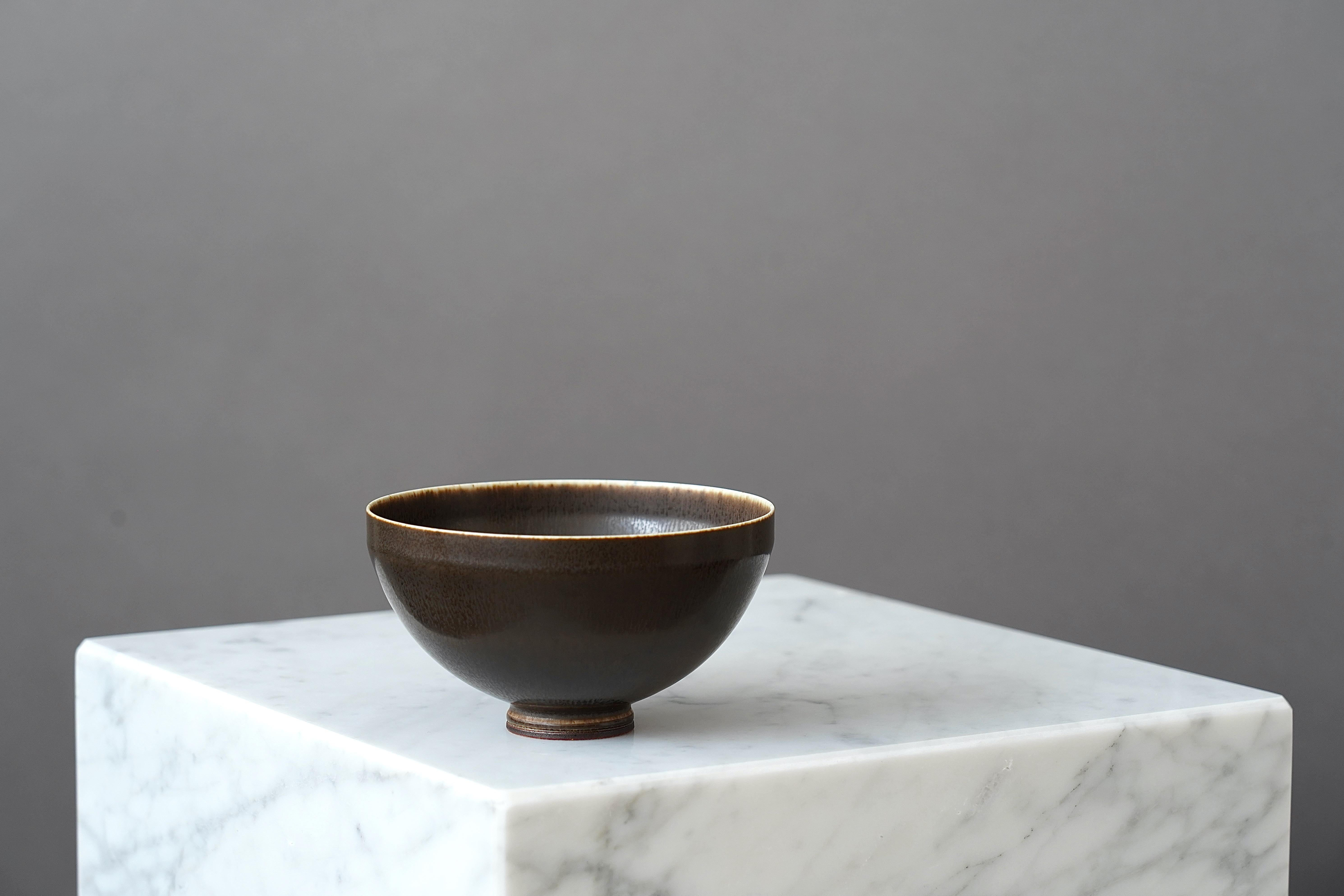 A beautiful stoneware bowl with amazing hare’s fur glaze.
Made by master thrower Berndt Friberg, in the artist's studio at Gustavsberg, Sweden.

Excellent condition. Incised signature 