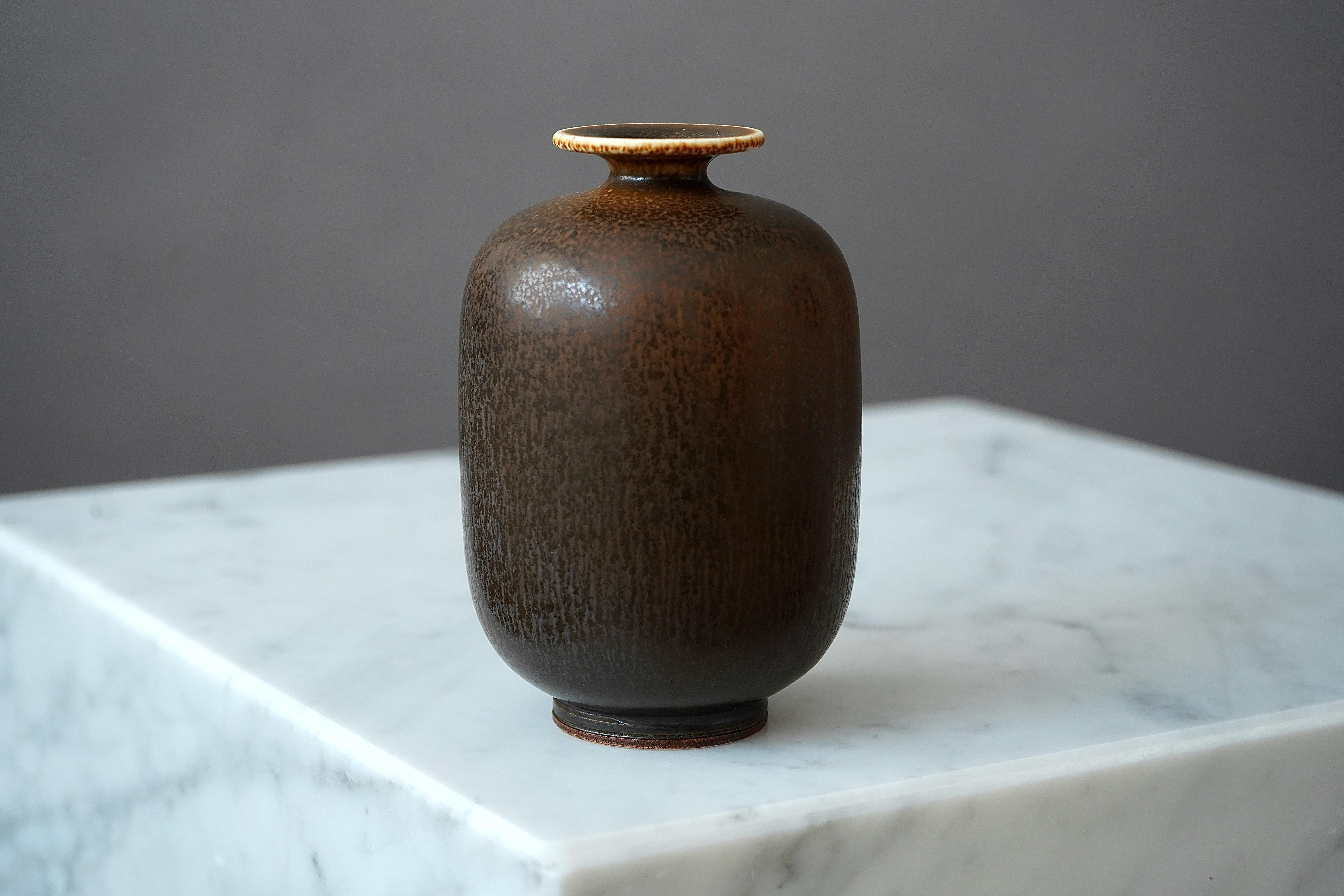A beautiful stoneware vase with amazing hare’s fur glaze.
Made by master thrower Berndt Friberg, in the artist's studio at Gustavsberg, Sweden.

Excellent condition. Incised signature 