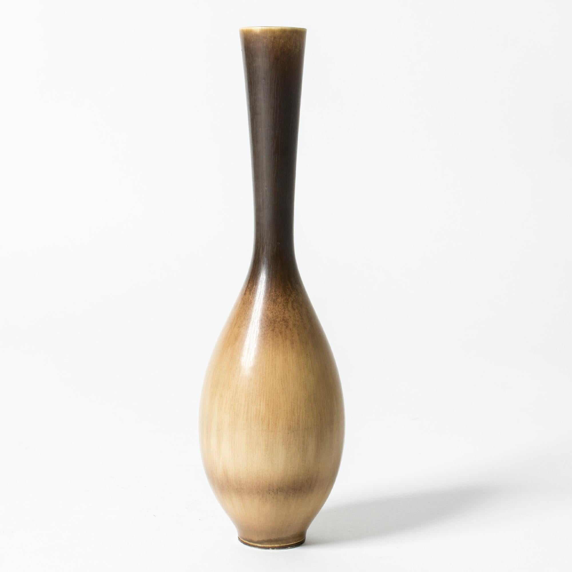 Elegant stoneware vase by Berndt Friberg. Bulbous base and slender neck, beautiful hare’s fur glaze in contrasting dark brown and caramel colors.

Berndt Friberg was a Swedish ceramicist, renowned for his stoneware vases and vessels for