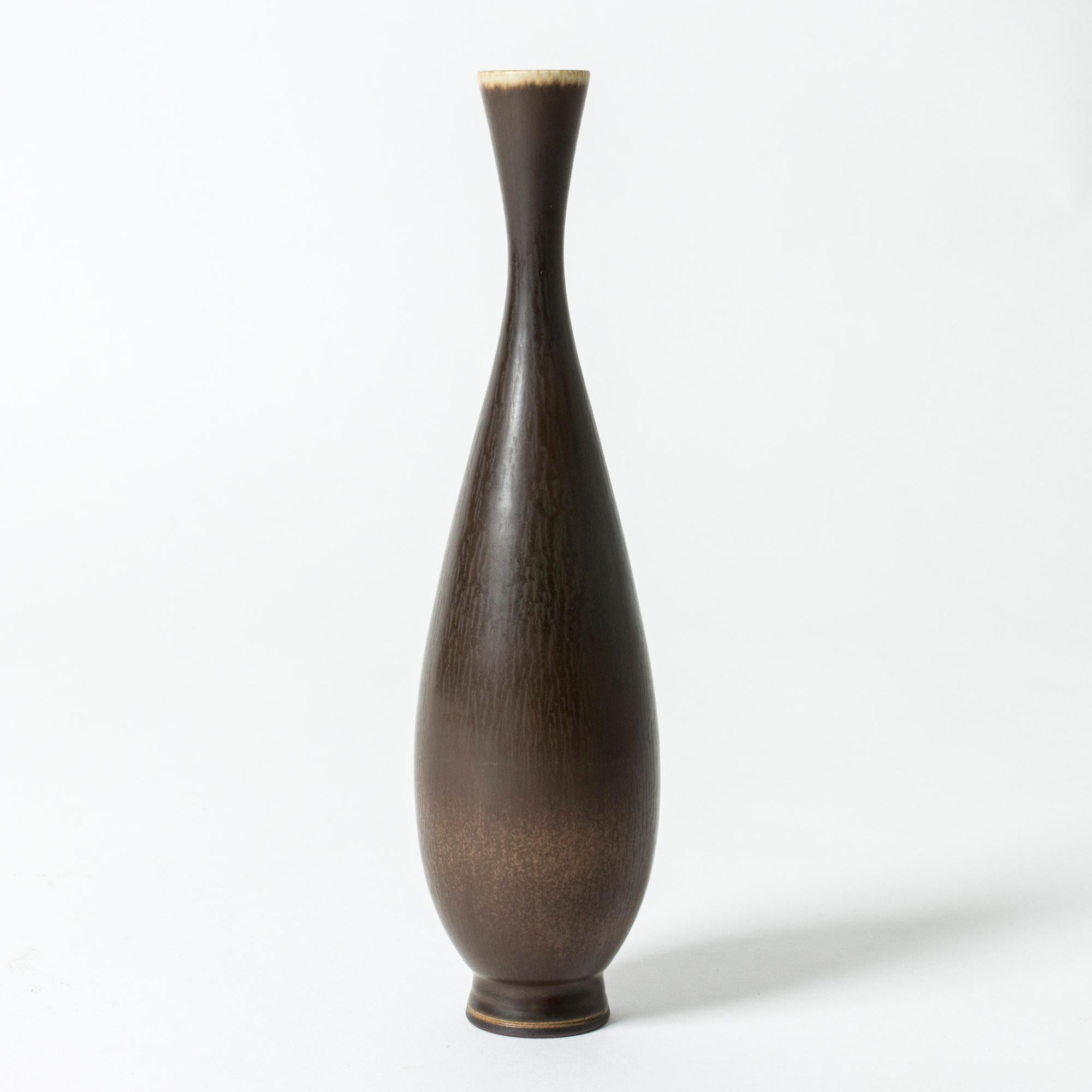 Elegant stoneware vase by Berndt Friberg. Sleek, curved form with rich brown hare’s fur glaze.

Berndt Friberg was a Swedish ceramicist, renowned for his stoneware vases and vessels for Gustavsberg. His pure, composed designs with satiny,