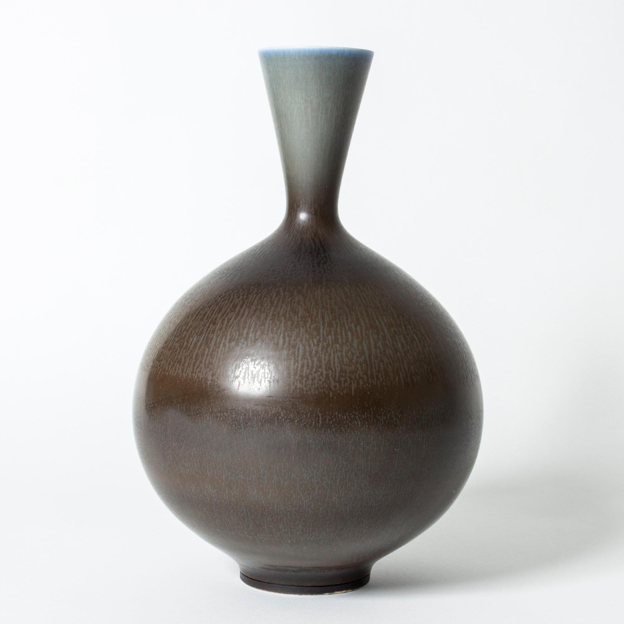 Oversized stoneware vase by Berndt Friberg, in a beautiful round form with a tapering neck. Brown hare’s fur glaze blending into pale blue.

Berndt Friberg was a Swedish ceramicist, renowned for his stoneware vases and vessels for Gustavsberg. His