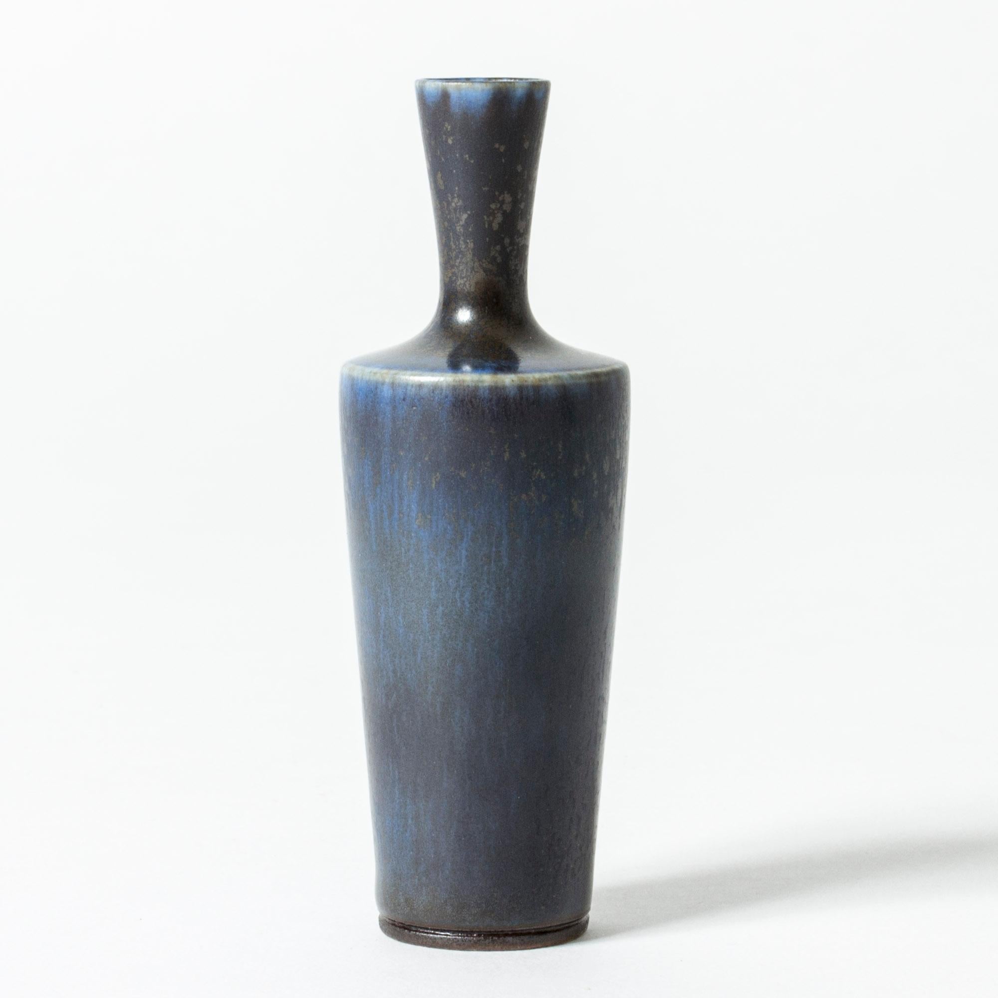 Neat miniature stoneware vase by Berndt Friberg, in a slim, strict form. Dark blue hare’s fur glaze.

Berndt Friberg was a Swedish ceramicist, renowned for his stoneware vases and vessels for Gustavsberg. His pure, composed designs with satiny,