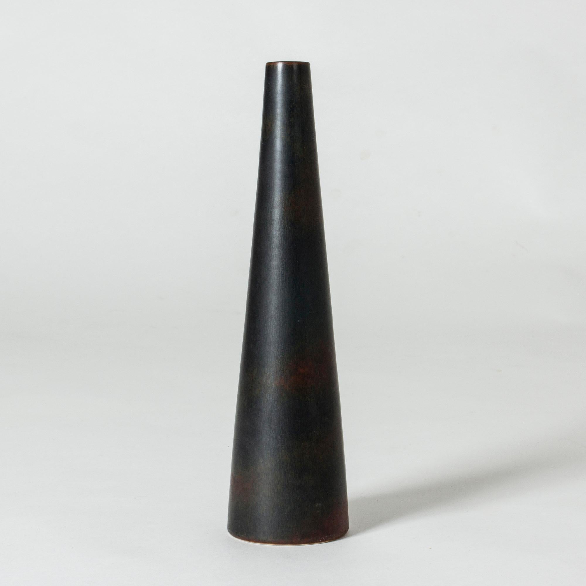 Stoneware vase by Carl-Harry Stålhane in a smooth, clean conical shape. Black hare’s fur glaze with dark red breaking the surface around the base.