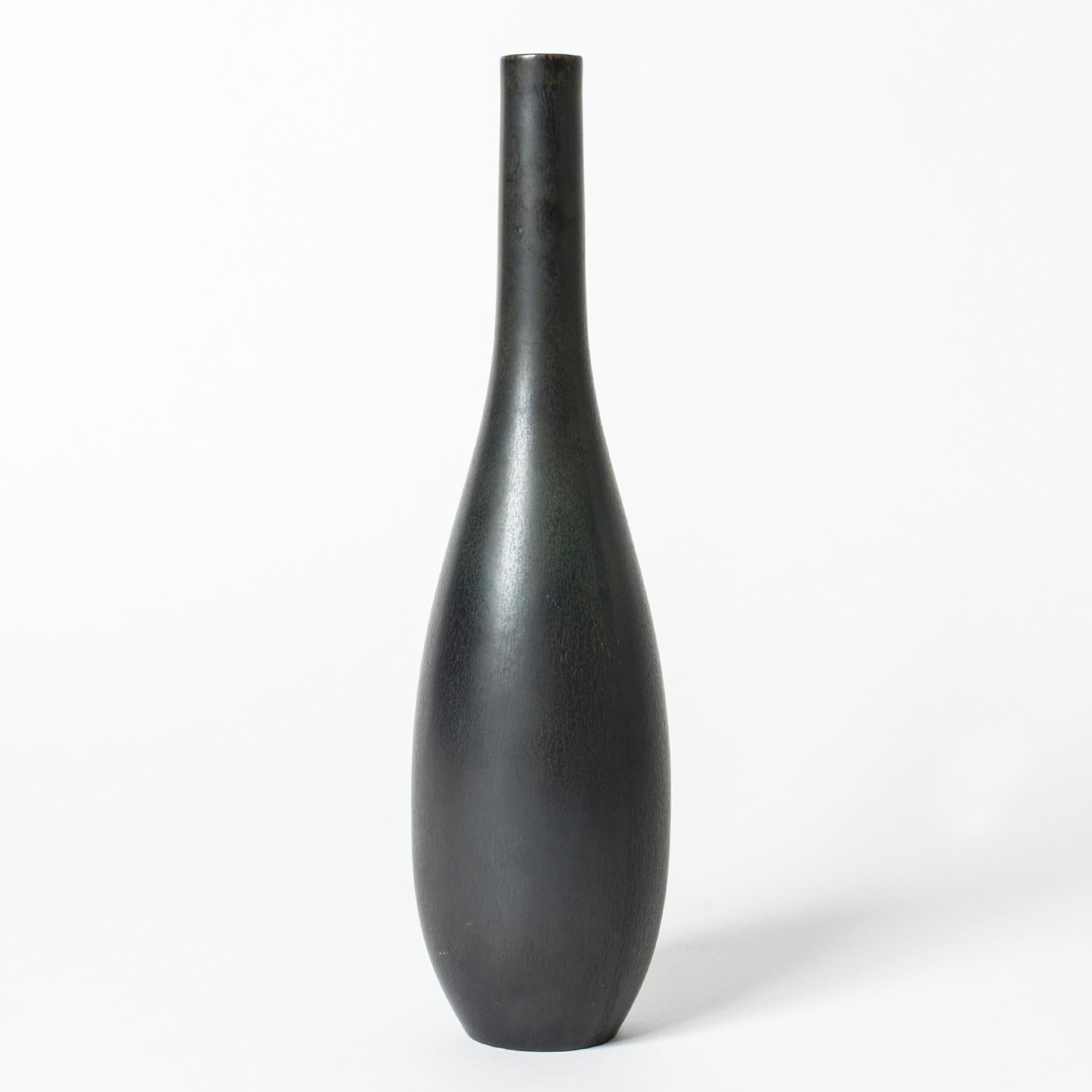 Cool stoneware vase by Carl-Harry Stålhane in a strict form. Dense black hare’s fur glaze.

Carl-Harry Stålhane was one of the stars among Swedish ceramic artists during the 1950s, 1960s and 1970s, whose designs are just as highly regarded and