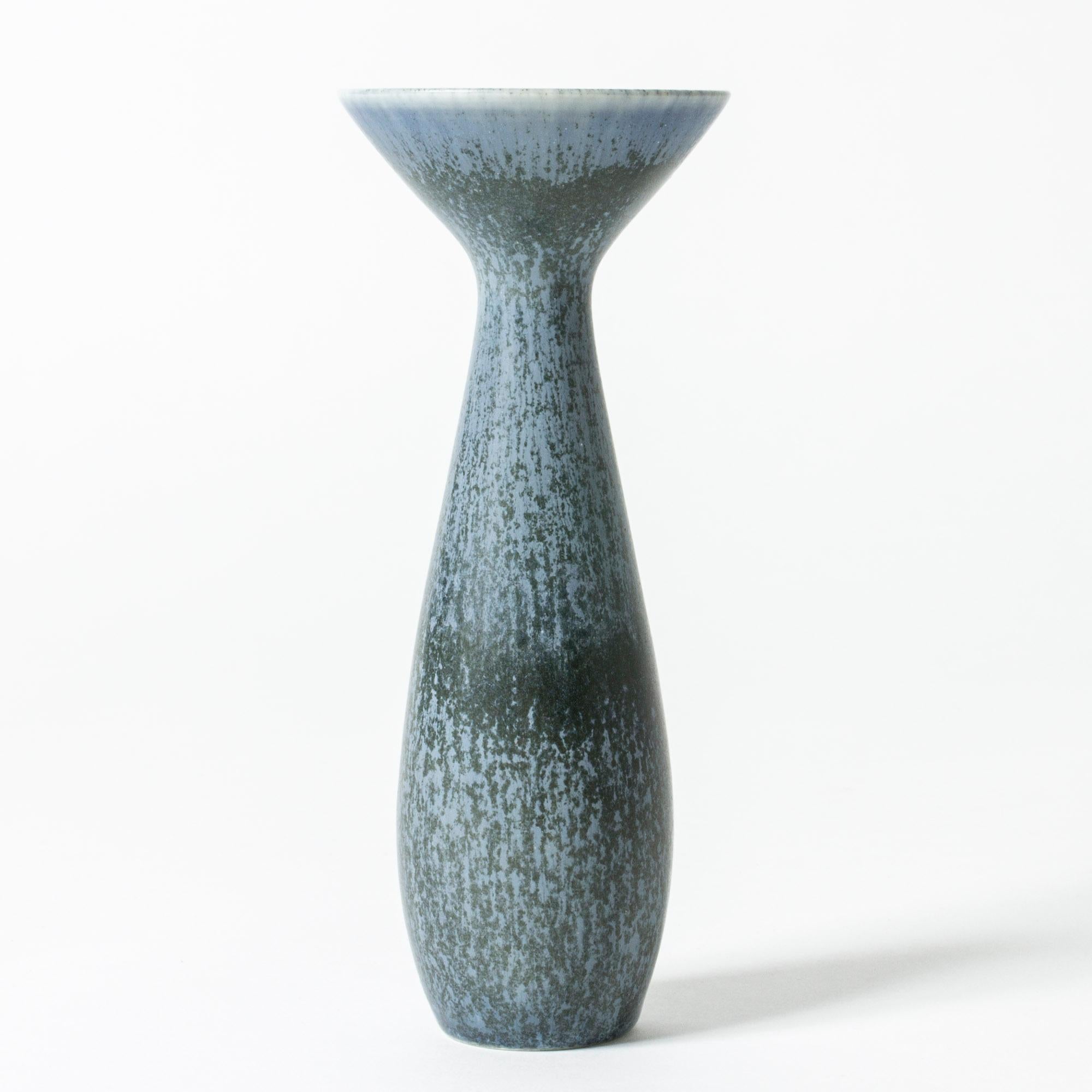 Stoneware vase by Carl-Harry Stålhane in an amazing shape with a wide-rimmed mouth and slender body. Rocky blue glaze with a grainy look.

Carl-Harry Stålhane was one of the stars among Swedish ceramic artists during the 1950s, 1960s and 1970s,