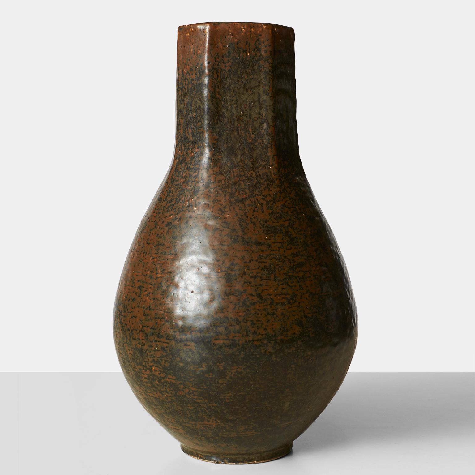 A stoneware vase by Eva Staehr-Nielsen, with octagonal mouth decorated with brownish glaze. Signed E.St.N. Manufactured and marked by Saxbo, Denmark.