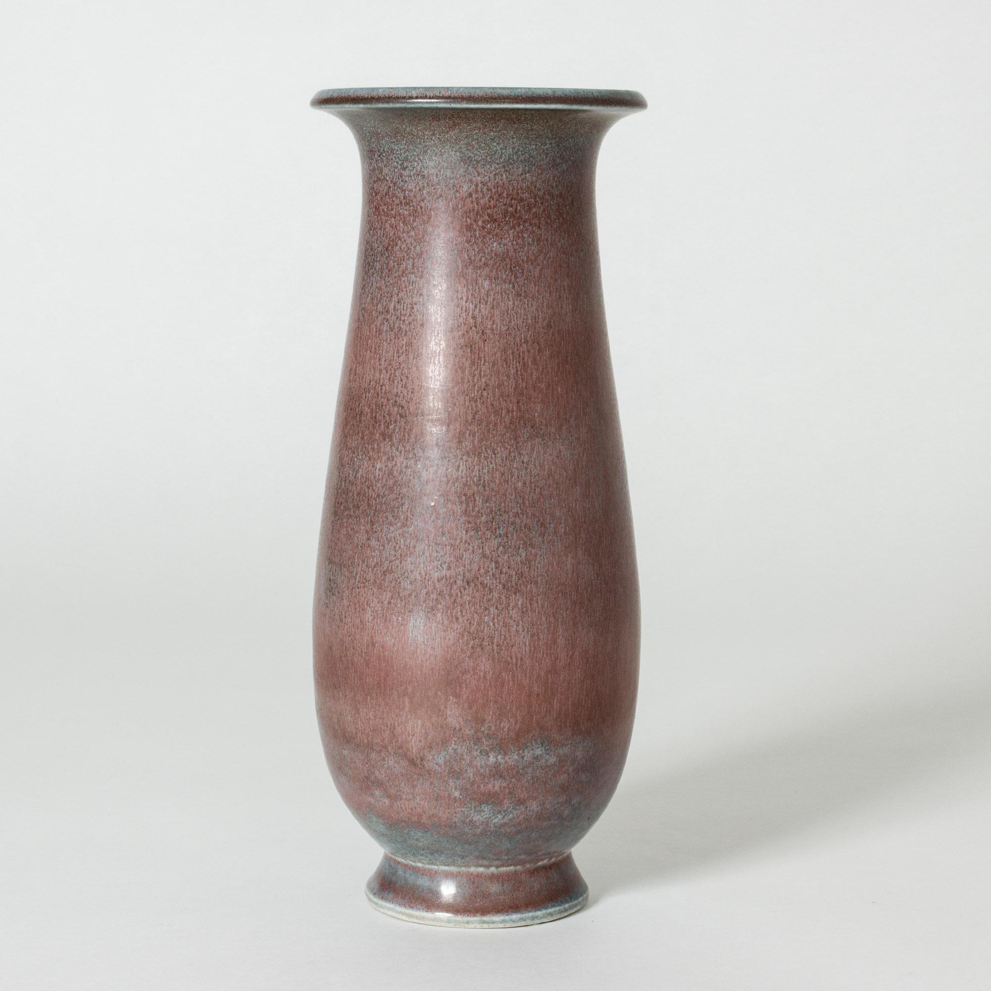 Beautiful stoneware floor vase by Gunnar Nylund with appealing soft lines. Amazing glaze in red and cool light blue shades.