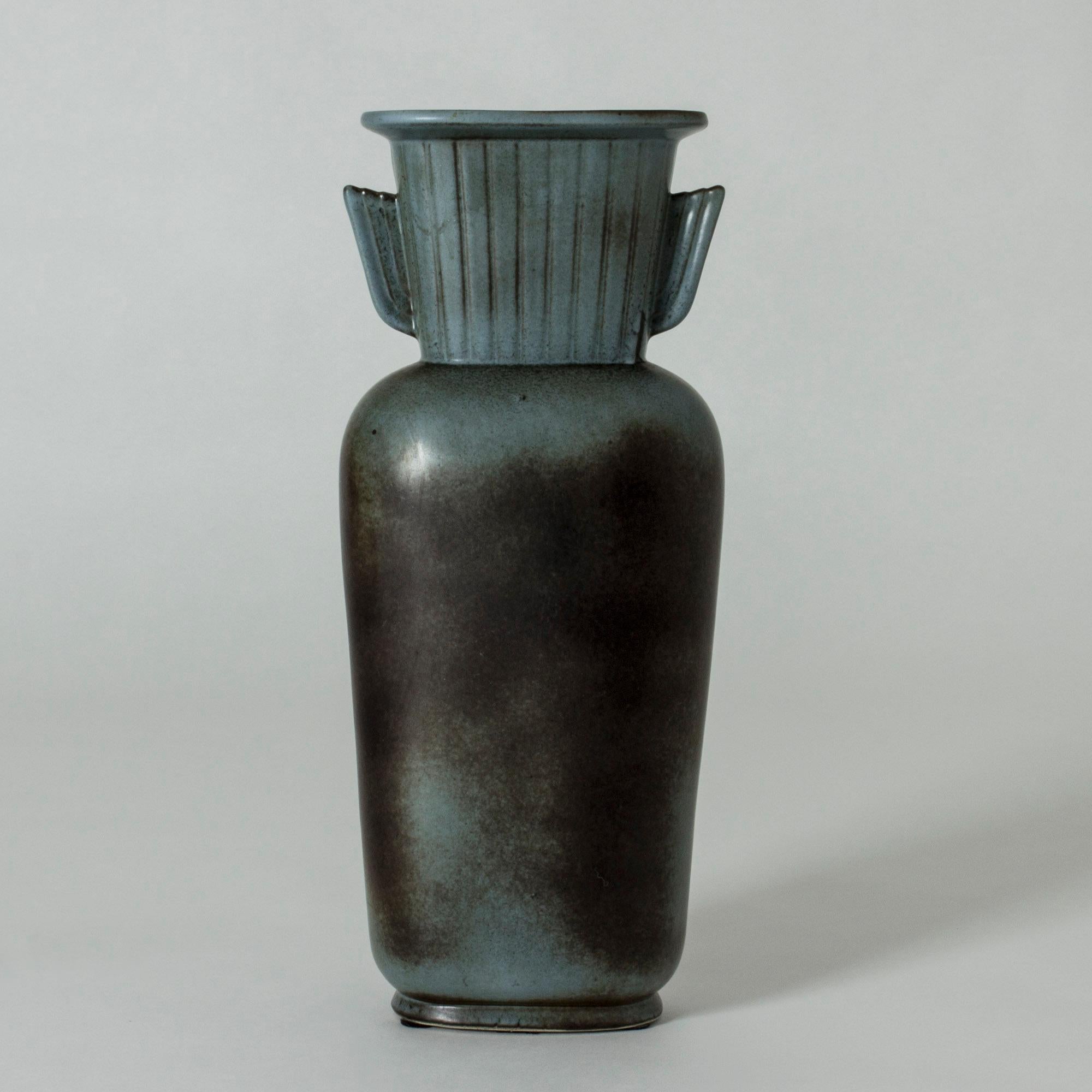 Tall stoneware vase in a statuesque design by Gunnar Nylund. Clean, soft lines. Beautiful matte glaze in the color of oxidized copper.