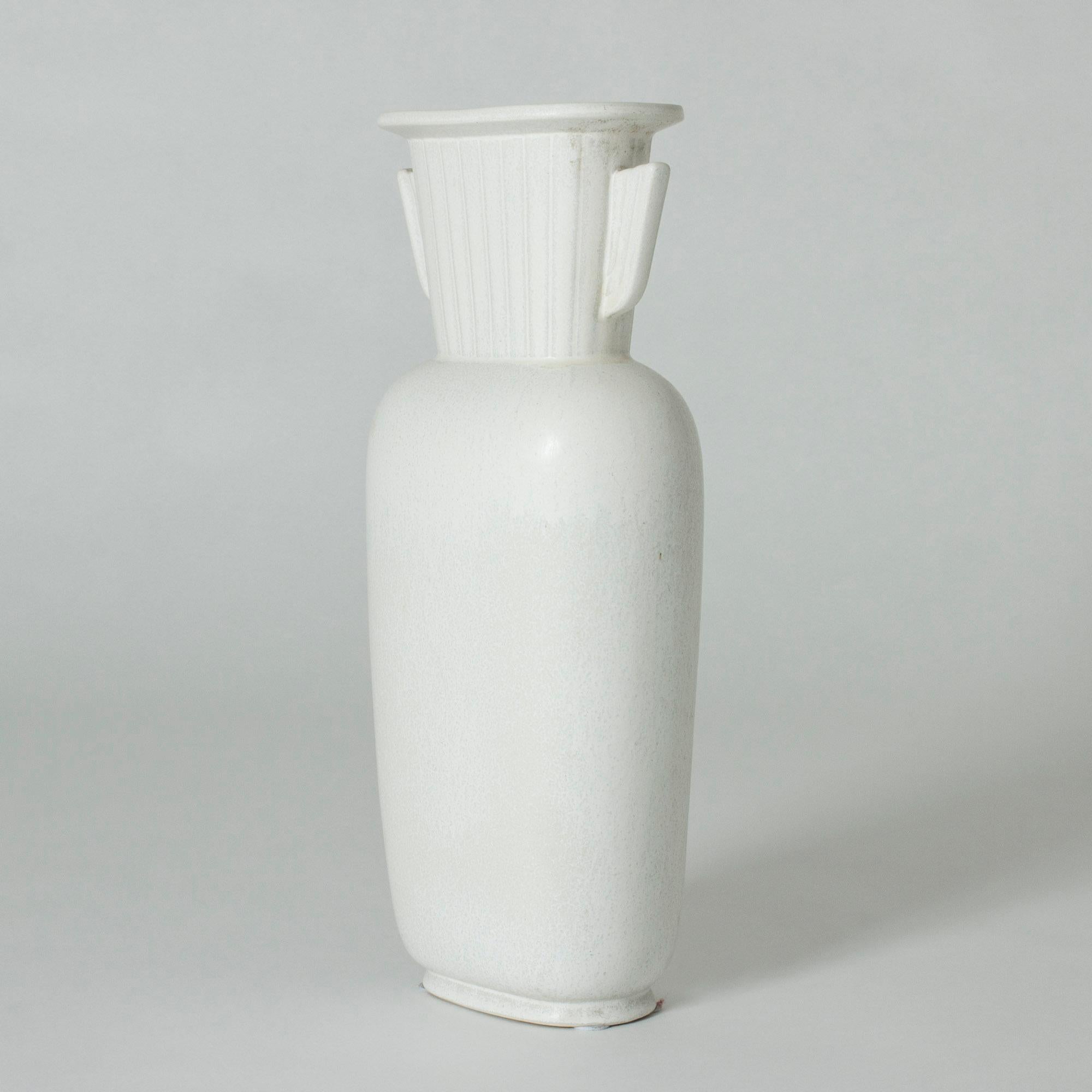 Tall stoneware vase in a statuesque design by Gunnar Nylund. Clean, soft lines. Beautiful eggshell glaze with a subtle “Mimosa” pattern.