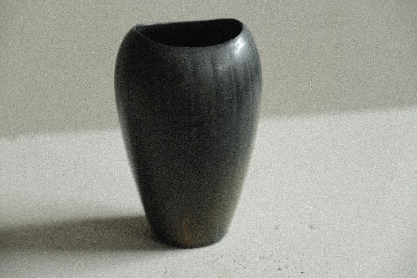 Stoneware vase in a clean form by Gunnar Nylund, the undulating rim softens the form. Vivacious blue, green and yellow glaze.

Signed underneath. 

Gunnar Nylund was one of the most influential ceramicists and designers of the Swedish mid-century