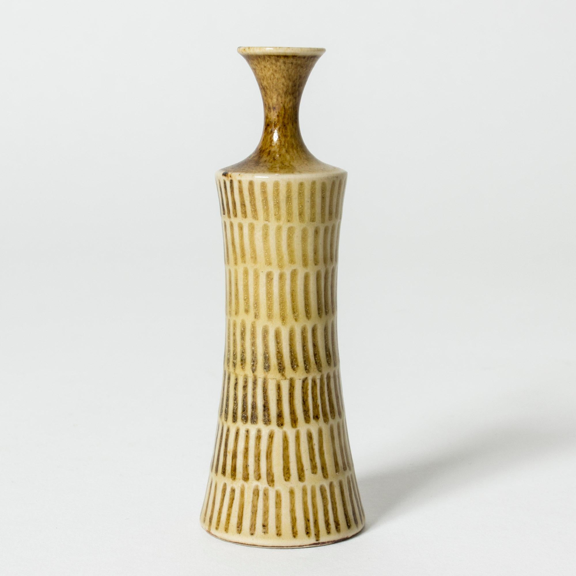 Cool unique miniature vase by Stig Lindberg. Slender stoneware form with a graphic pattern, glazed pale yellow and brown with a glossy surface.