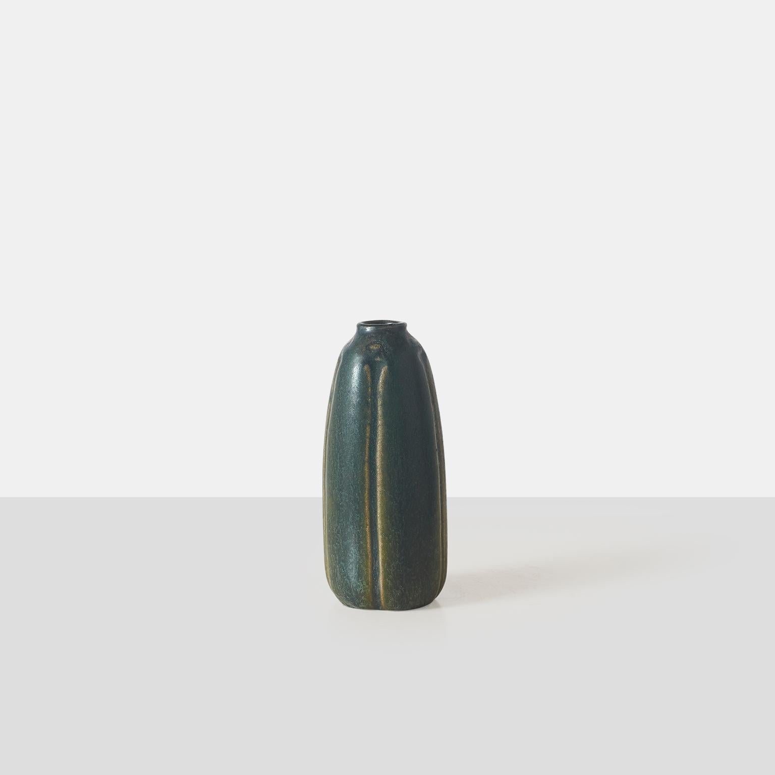 A tapering fluted stoneware bud vase in green, blue and earth tones. Makers mark and date stamped on base.