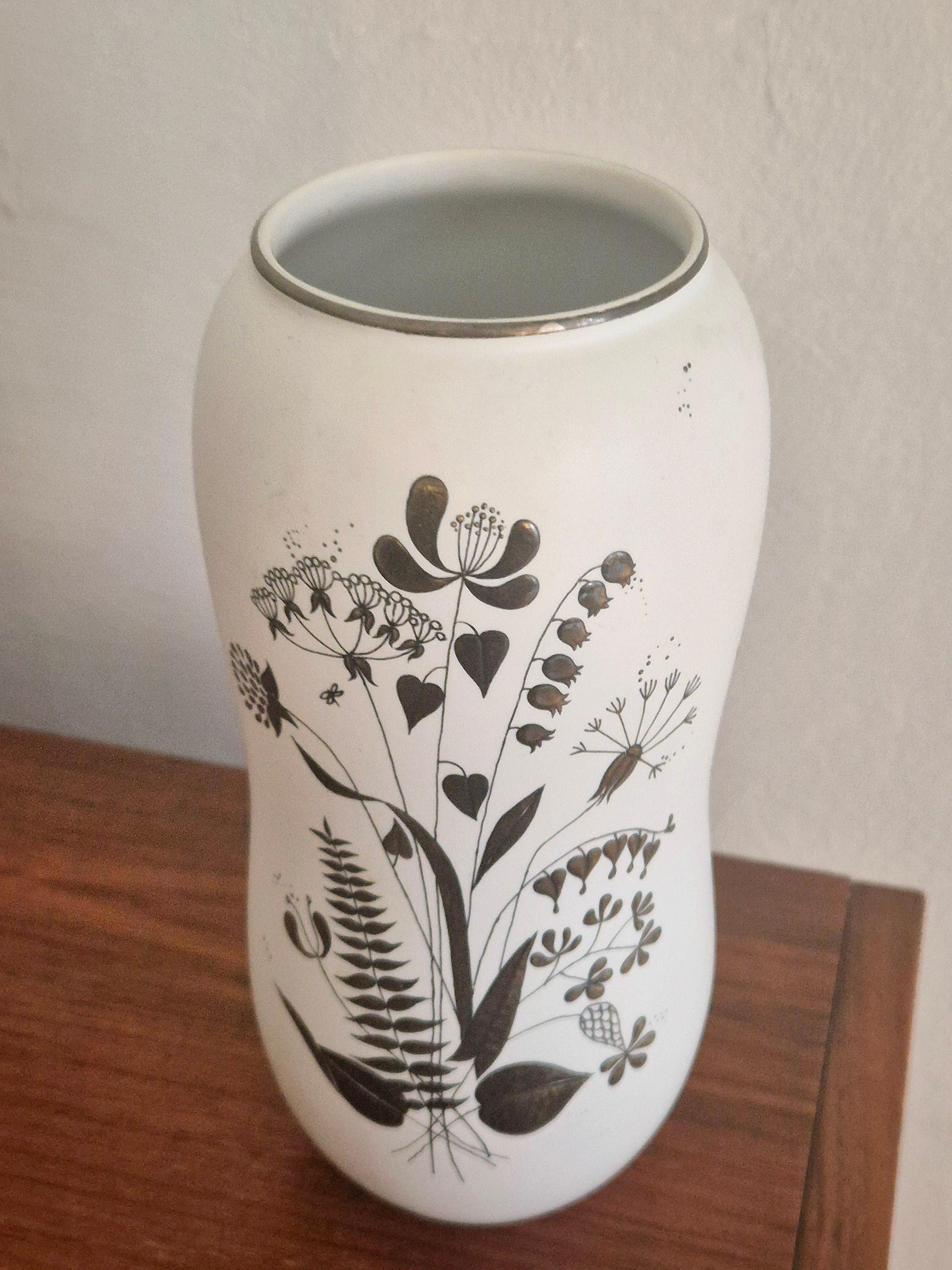 Vaso decorativo in gres con decorazioni in argento, raffigurante un bouquet di fiori. 

Progettato dal leader artistico di Gustavsberg (dal 1949, a  21 anni, al 1957) Stig Lindberg. Modello Grazia, 217, marcato con Gustavsberg, ancora, Made in
