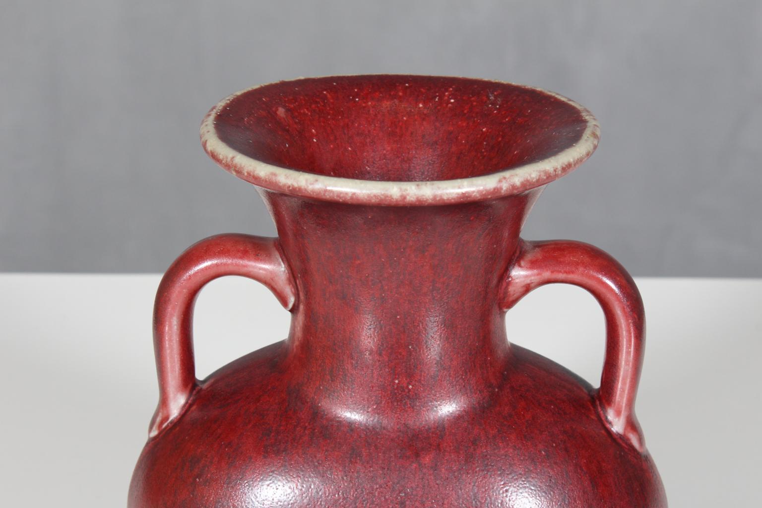 Beautiful stoneware ceramic vase by Bode Willumsen for Royal Copenhagen. In oxblood colored matte glaze and features. 

Marked with Royal Copenhagen (crown) Denmark and the three rivers mark.