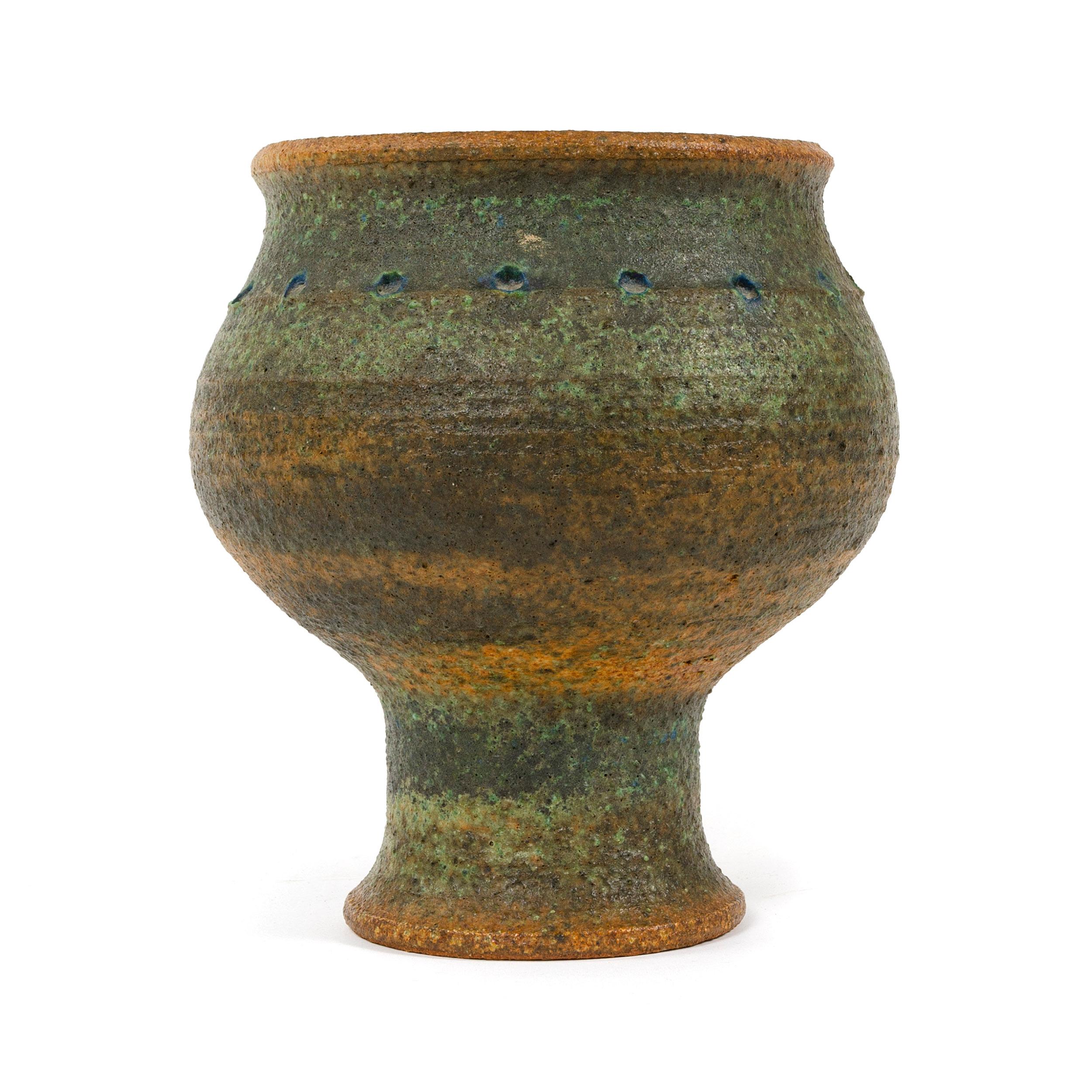 A Mid-Century Modern hand-thrown, studio-made footed stoneware vessel with a rustic and textured glaze. Made by Arabia in Finland, 1960s.
Base diameter is 4.25