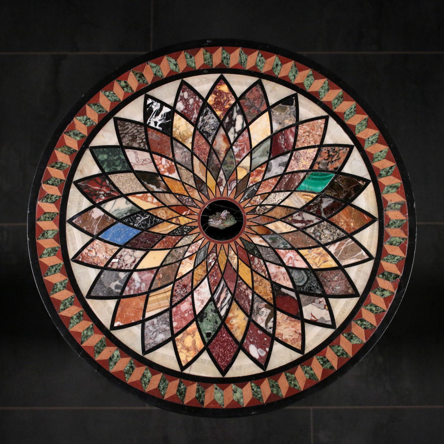 Black marble round table with sample case. In the midde there is a Belgian Black round contaninig a micro mosaic that represents Pliny’s Doves; thanks to a complex geometric system of ellipses, from the central round start a serie of diamonds that
