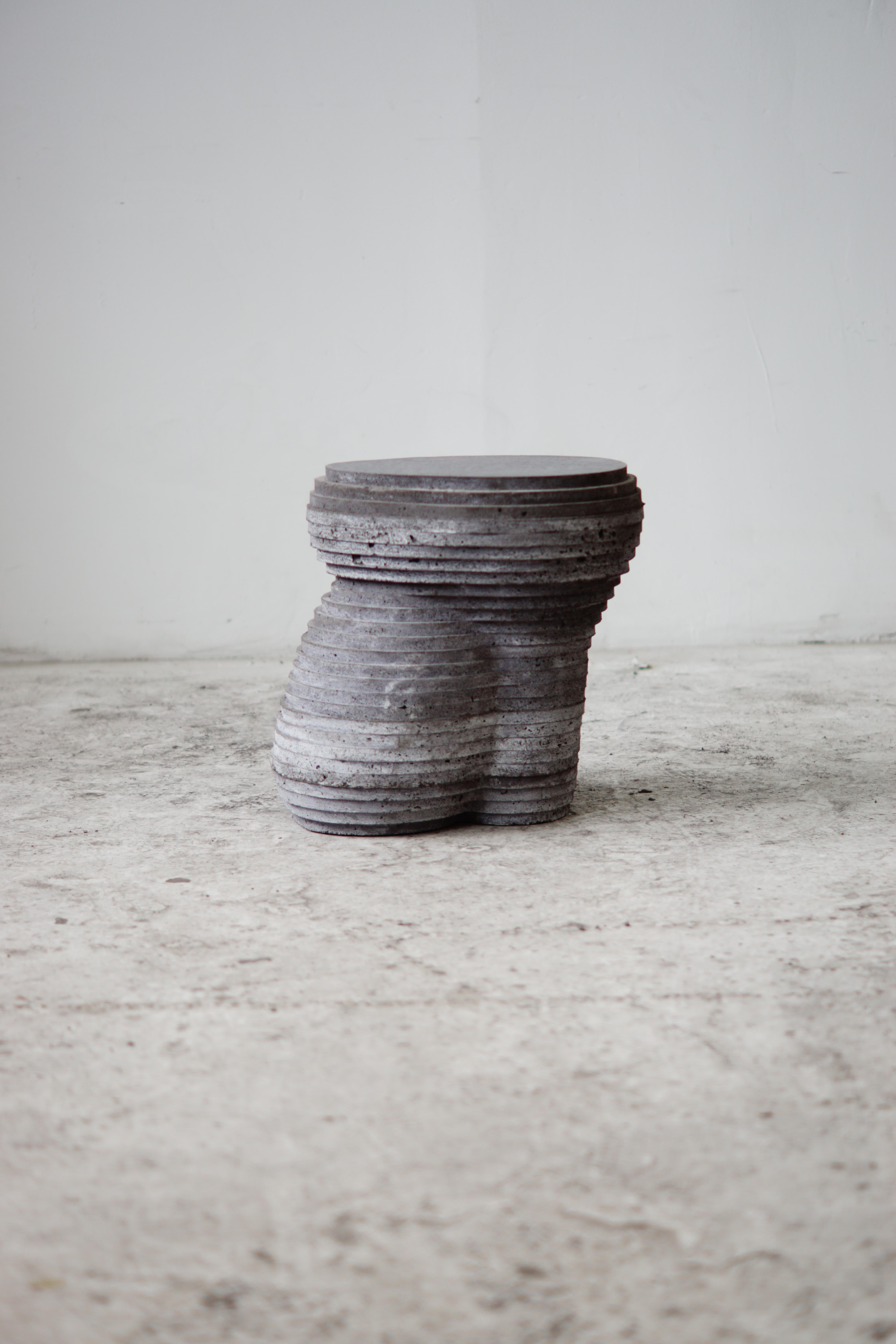 Hand-cast concrete stool/ side table for indoor and outdoor use.

At the intersection of art, craft, and design, Concrete Poetics' debut collection of hand-cast cement sculptural furniture and accessories streamlines visually intriguing and dynamic