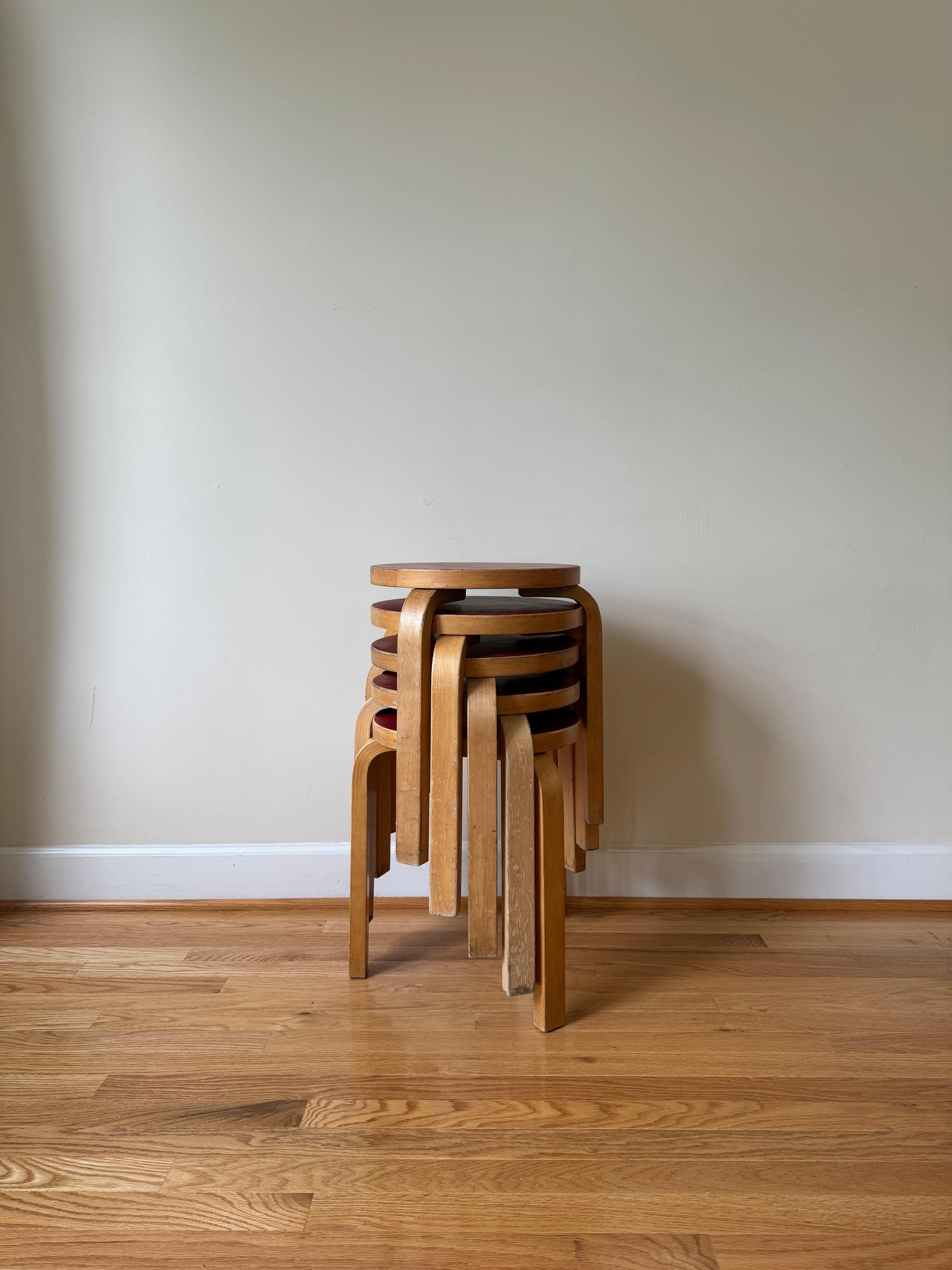 1960s models with four slits and five slits in the L-legs.
Date of Manufacture: circa 1960s

Alvar Aalto's iconic Stool 60 is the most elemental of furniture pieces, equally suitable as a seat, a table, storage unit, or display surface. 
Born of