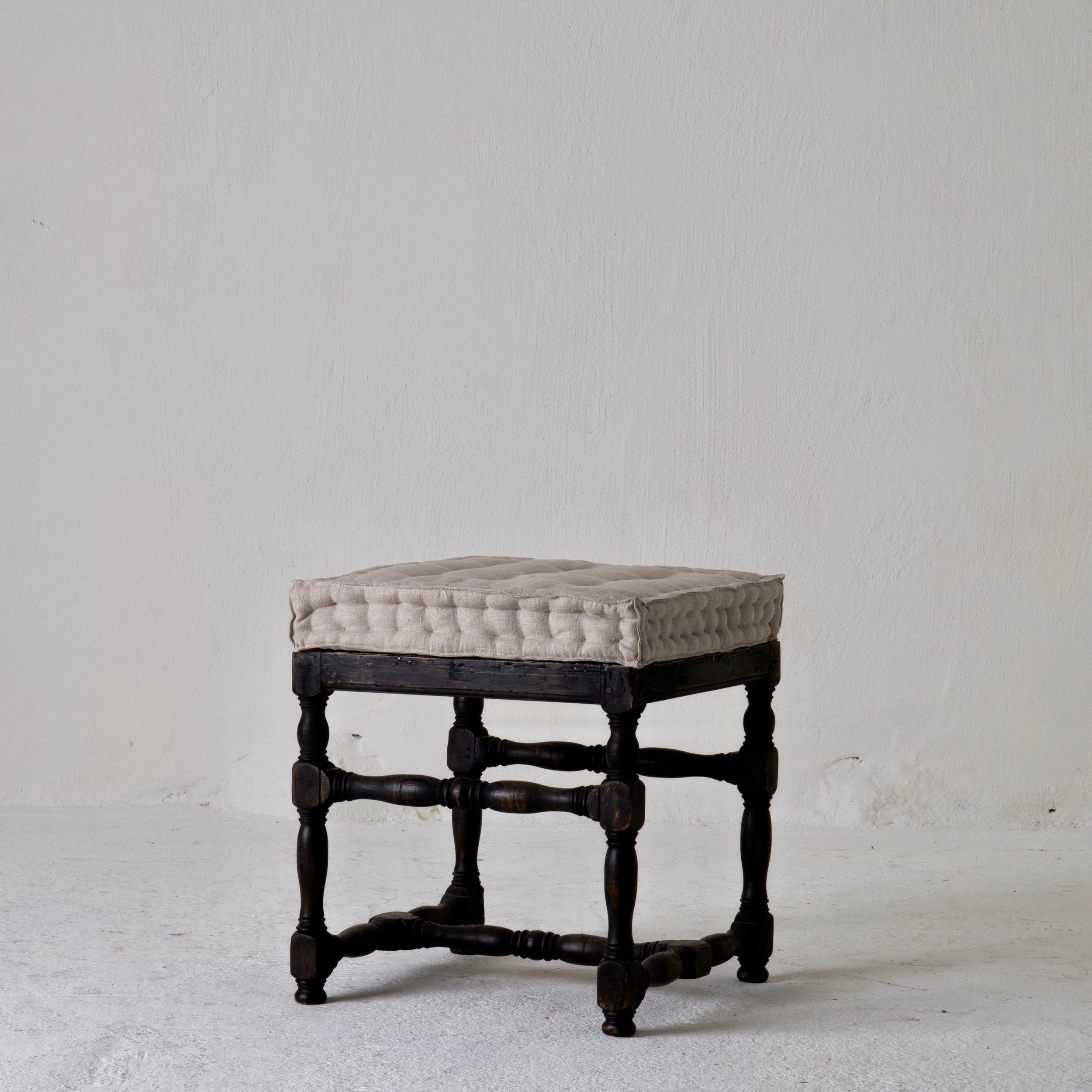 Stool bench Swedish baroque black Sweden. A stool made in Sweden during the baroque period 1650-1750. Loose cushion made from natural linen.


   