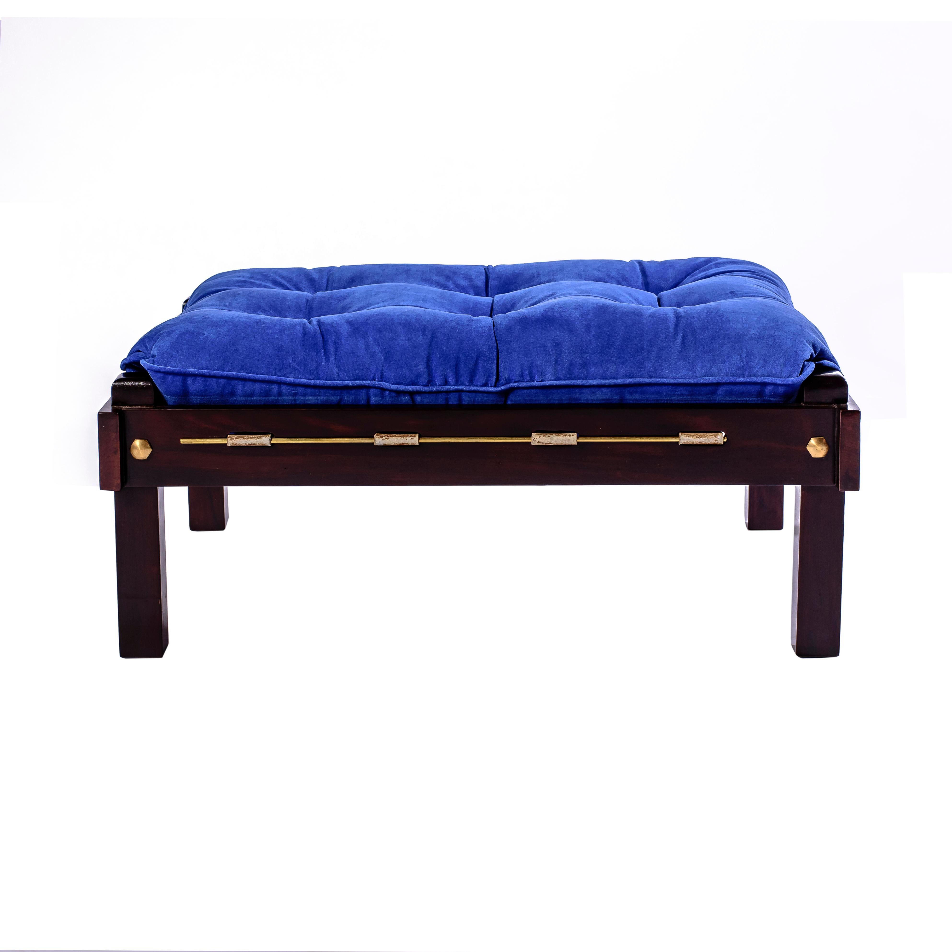 This low stool from the 1950s captures the sensual tactility and material sophistication that define mid-century Brazilian design. Crafted in solid jacarandá rosewood with a deep, structural frame and accented by a rich blue upholstered cushion, it