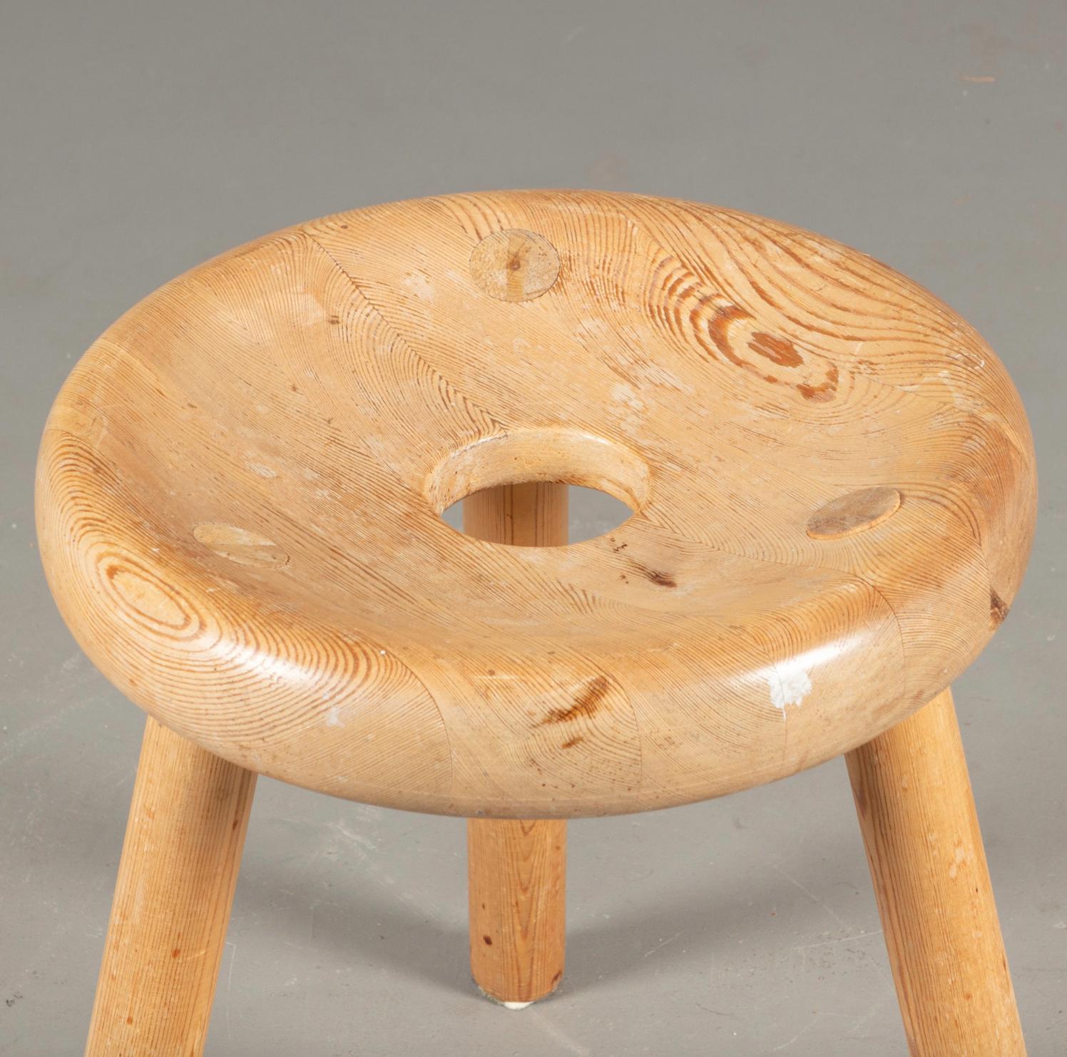 wooden stool with hole in middle