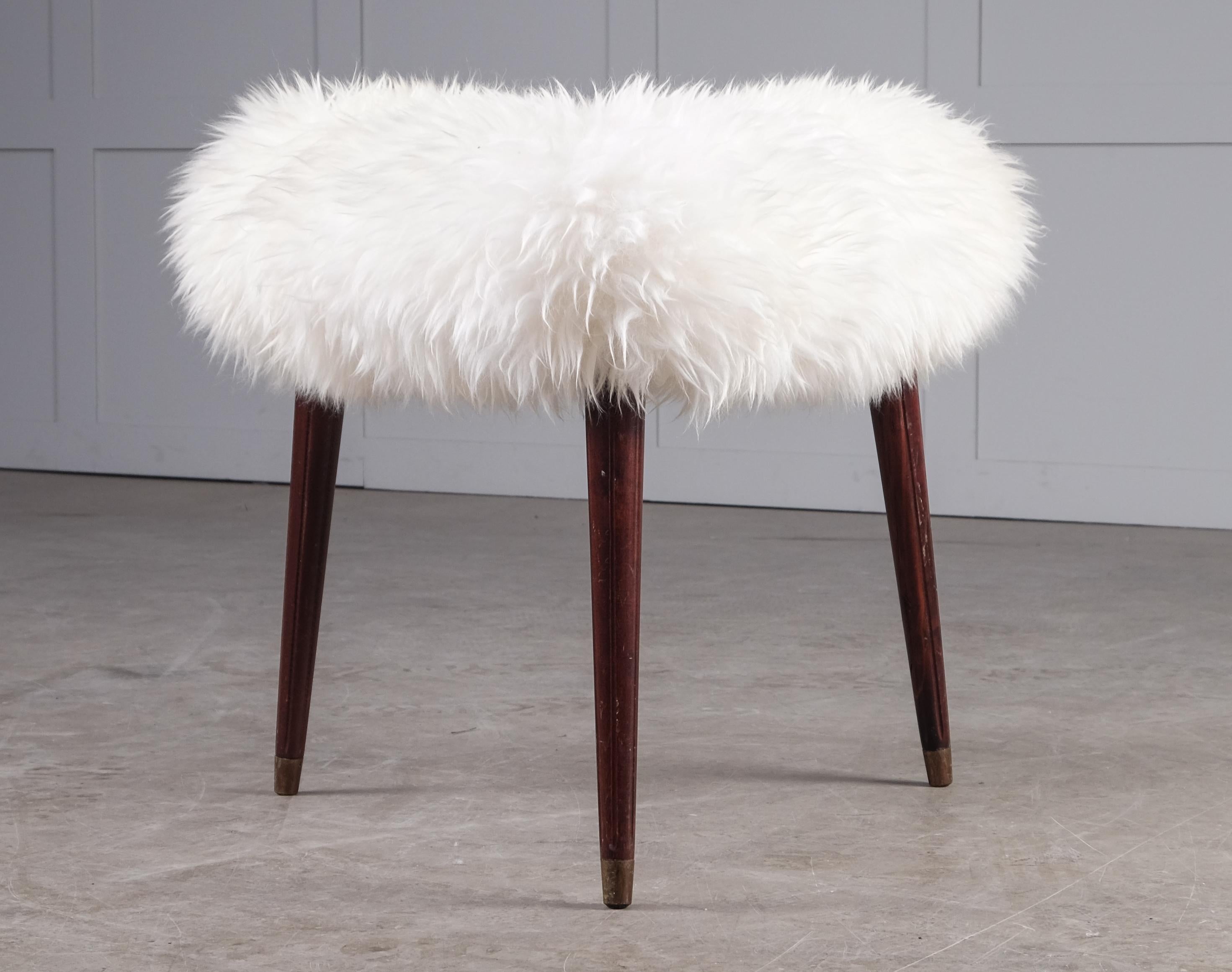 Three legged stool produced by Bröderna Andersson, Sweden, 1950s. 
Newly upholstered in sheepskin.