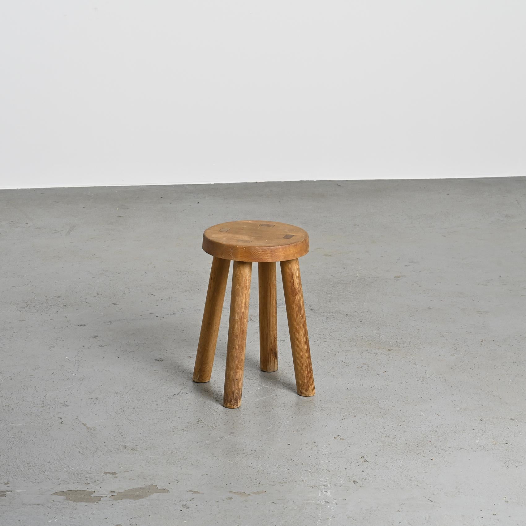 Iconic design by Charlotte Perriand, this stool was conceived in the 1950s to furnish the ski resort of Les Arcs in the French Alps.

This piece is an early edition, directly sourced from the resort.

The pine structure consists of four rounded legs