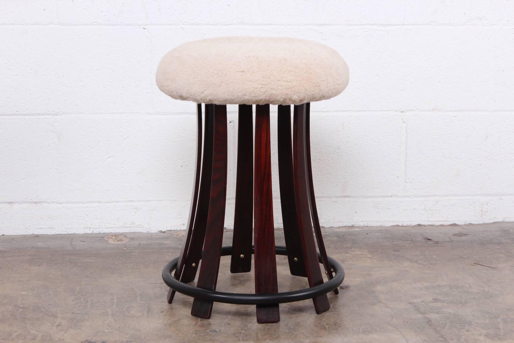 An ash stool with sheepskin cover seat. Designed by Edward Wormley for Dunbar.