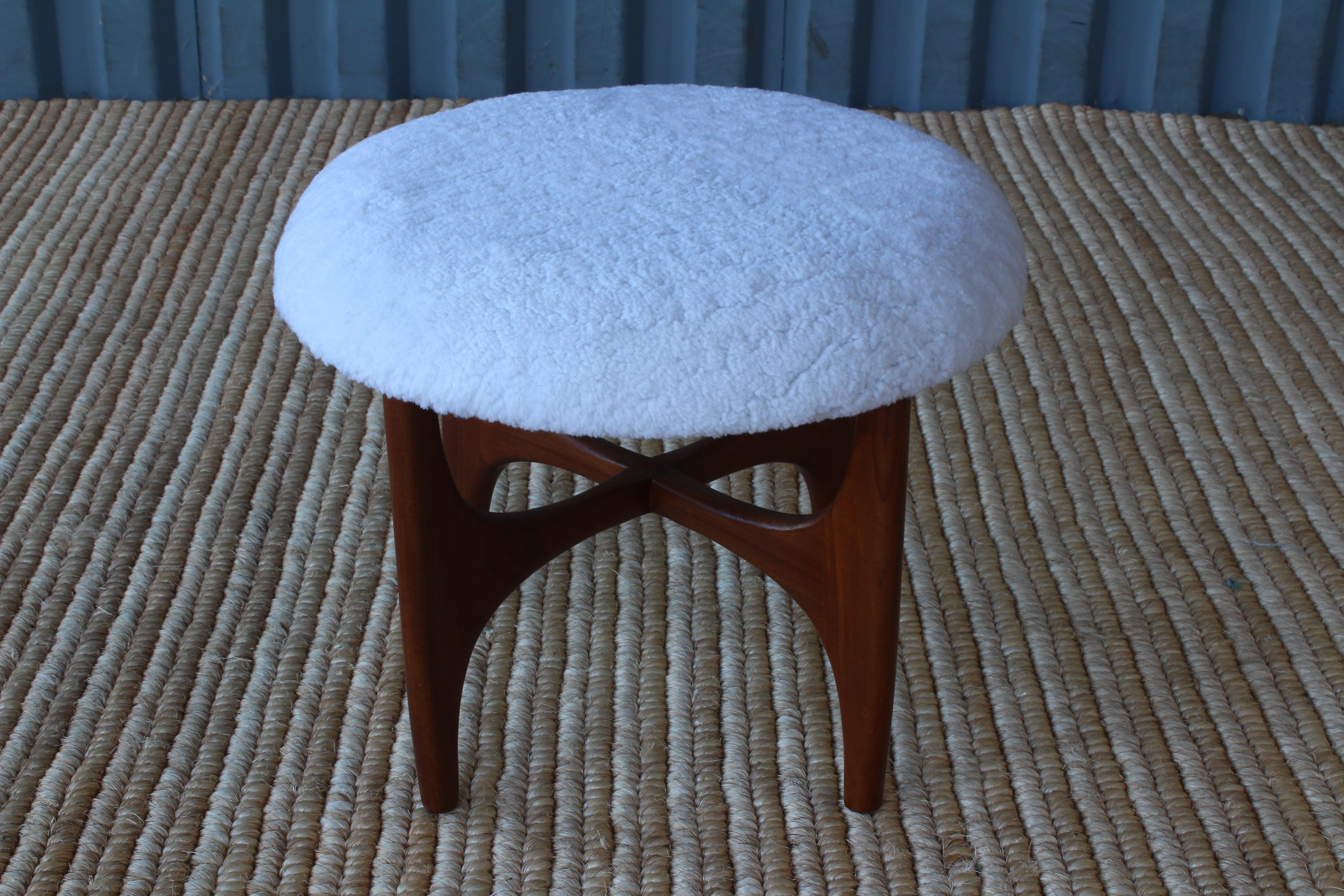 Footstool by G-Plan, England, 1950s. Recently refinished teak base and new white shearling upholstery.