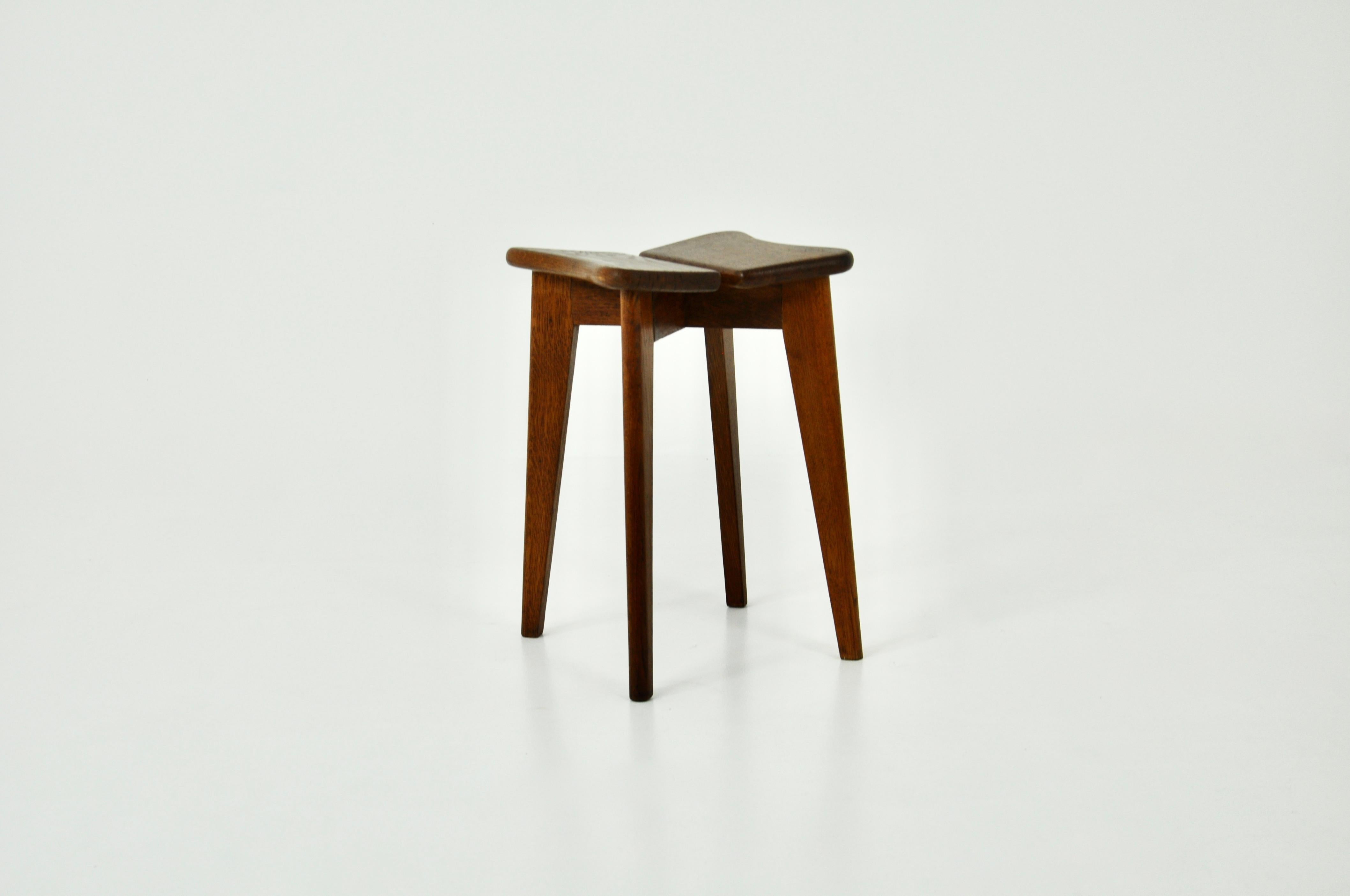 Wooden stool by Marcel Gascoin. Wear due to time and age of the stool.
