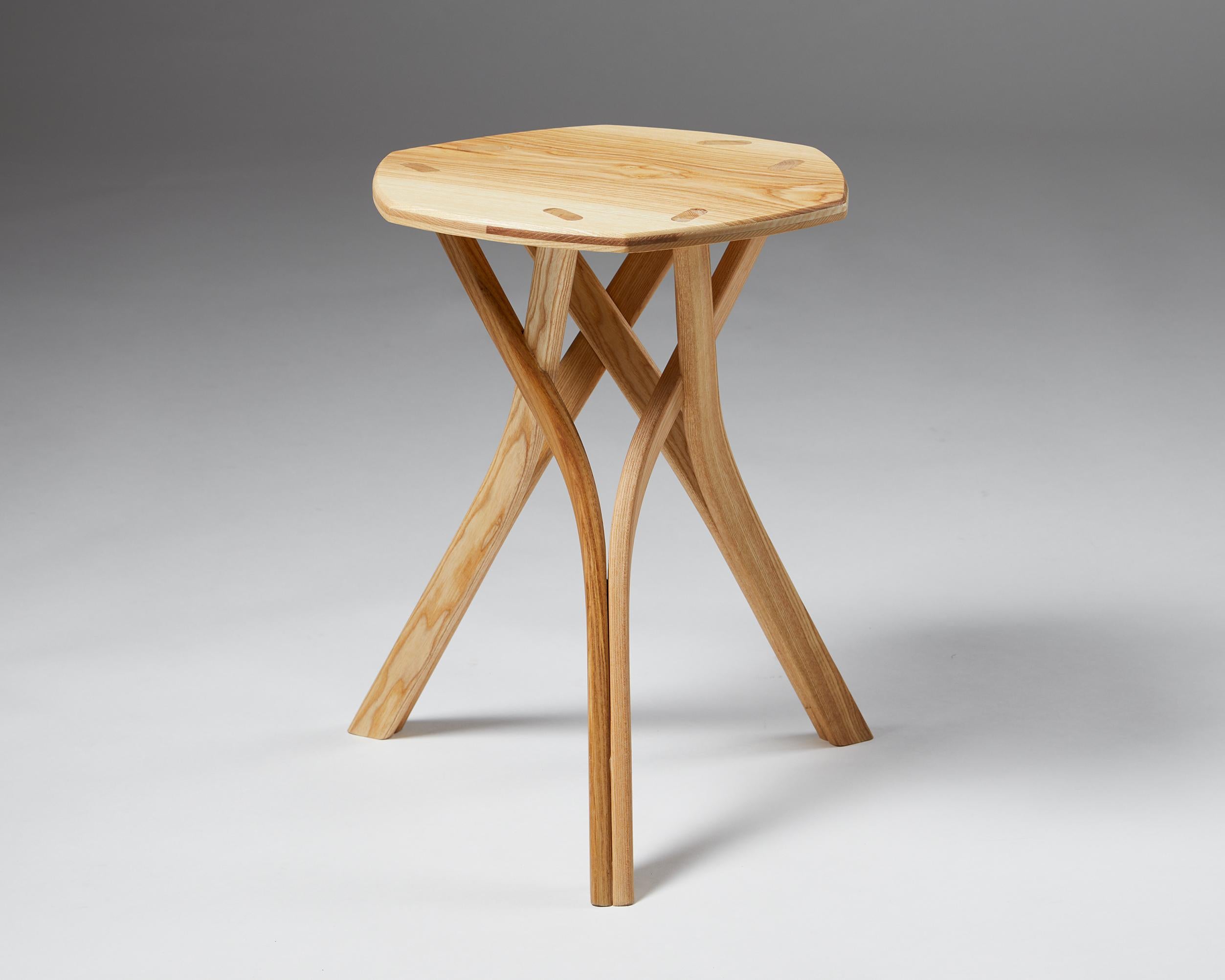 Stool designed by Calle Warfvinge,
Sweden. 

Contemporary.

Ash.

Unique.

Engraved ‘CW’.

This contemporary Swedish stool is a work of unparalleled craftsmanship. Calle Warfvinge carefully chose the individual wooden components to achieve a
