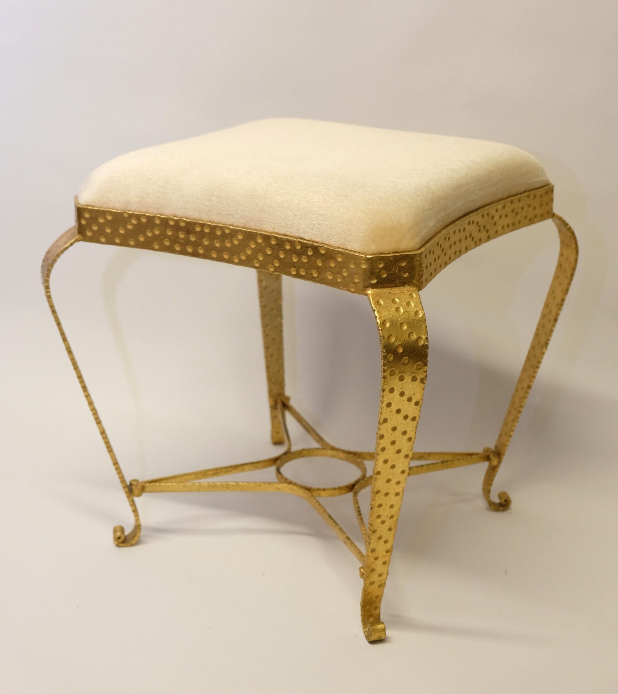 Stool by Pier Luigi Colli, Italy 1950s. 

Hammered gold plated metal with a fine cream fabric upholstery. Very good workmanship and elegant appearance.

Nice, well-maintained condition. The gilding on the frame has come off in a few