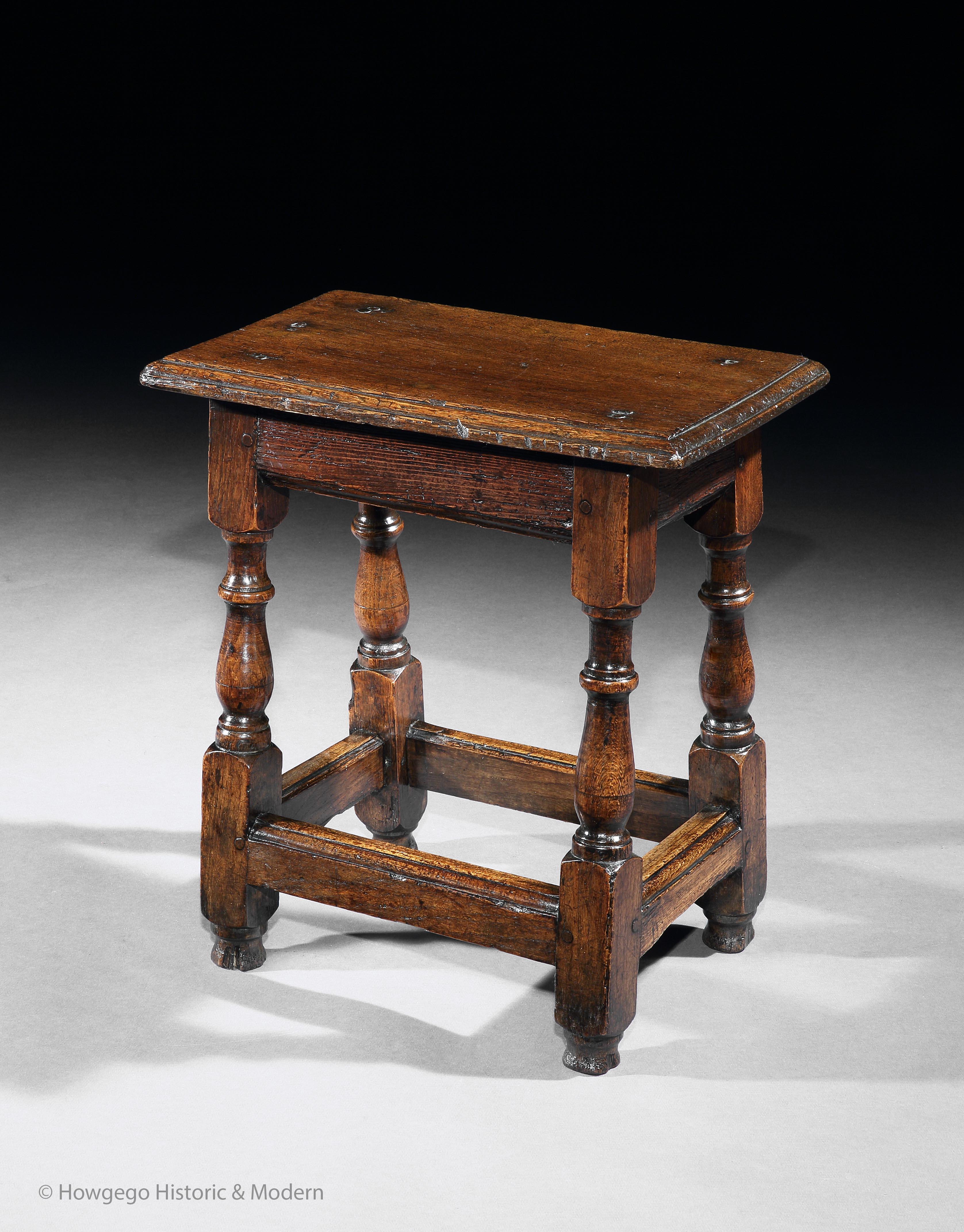 Characterful, naive charm
Perfect height for occassional table beside armchair or sofa for a drink and nibbles

A mid-17th century oak joint stool. The plank top with a moulded edge. Two sets of metal nails and another set of screws show where it