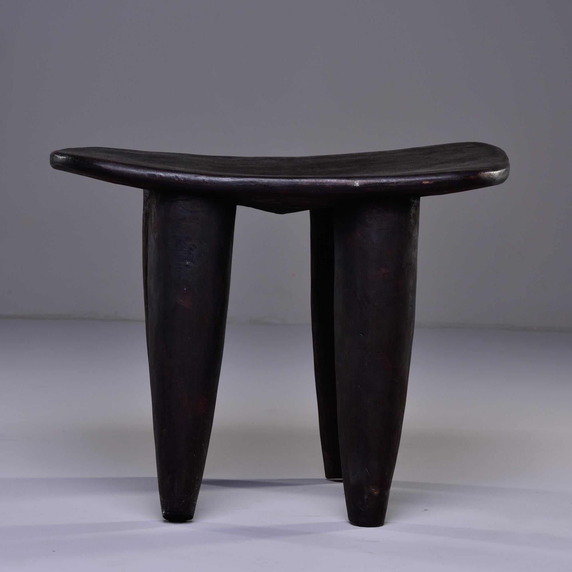 Circa 1980s stool or side table is hand carved with thick, tapered legs by Senufo people of Cote d’Ivoire. 
  