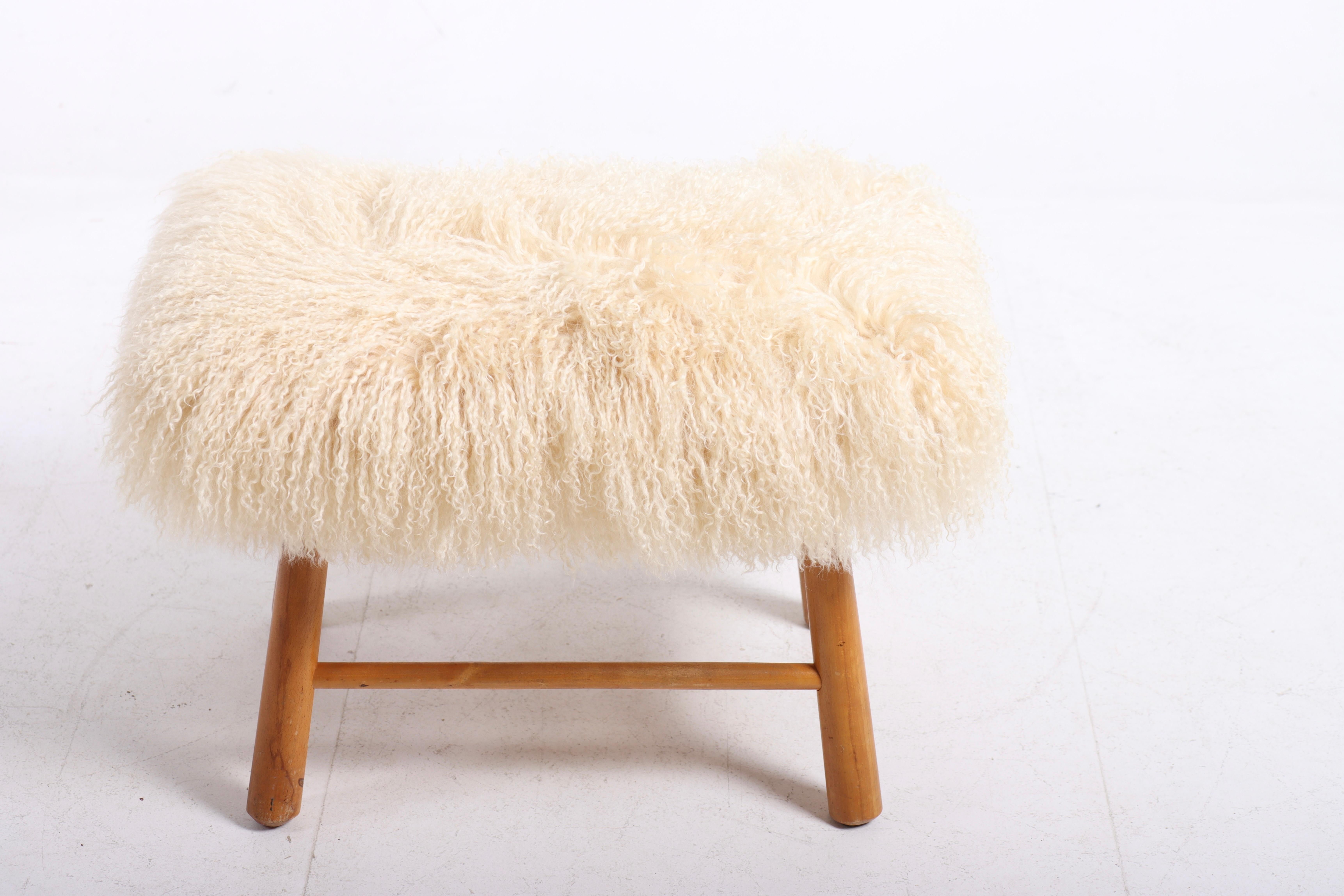 Ottoman reupholstered with sheepskin. Designed and made in Denmark. Great condition.